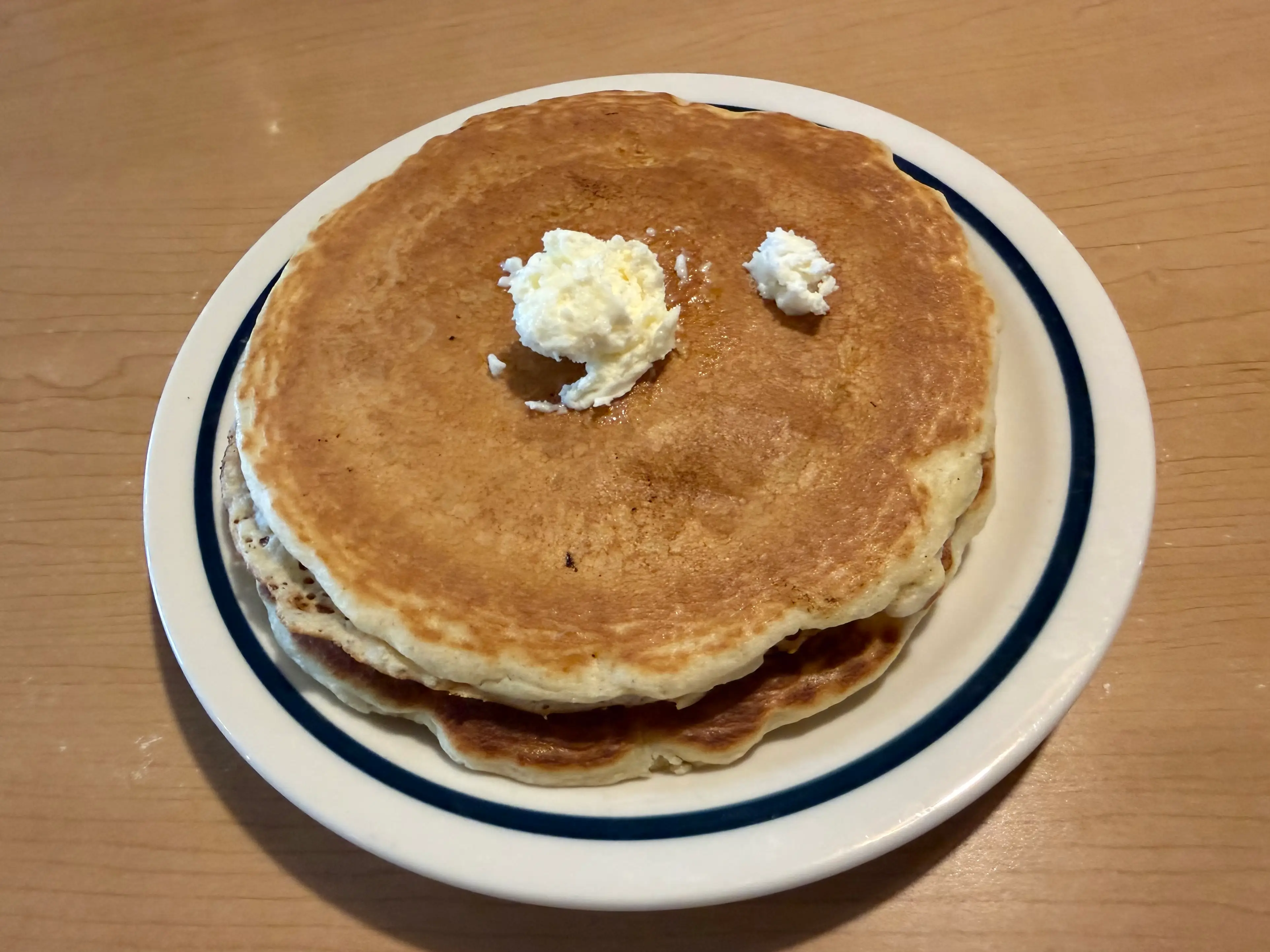Pancakes on plate at IHOP with butter on top