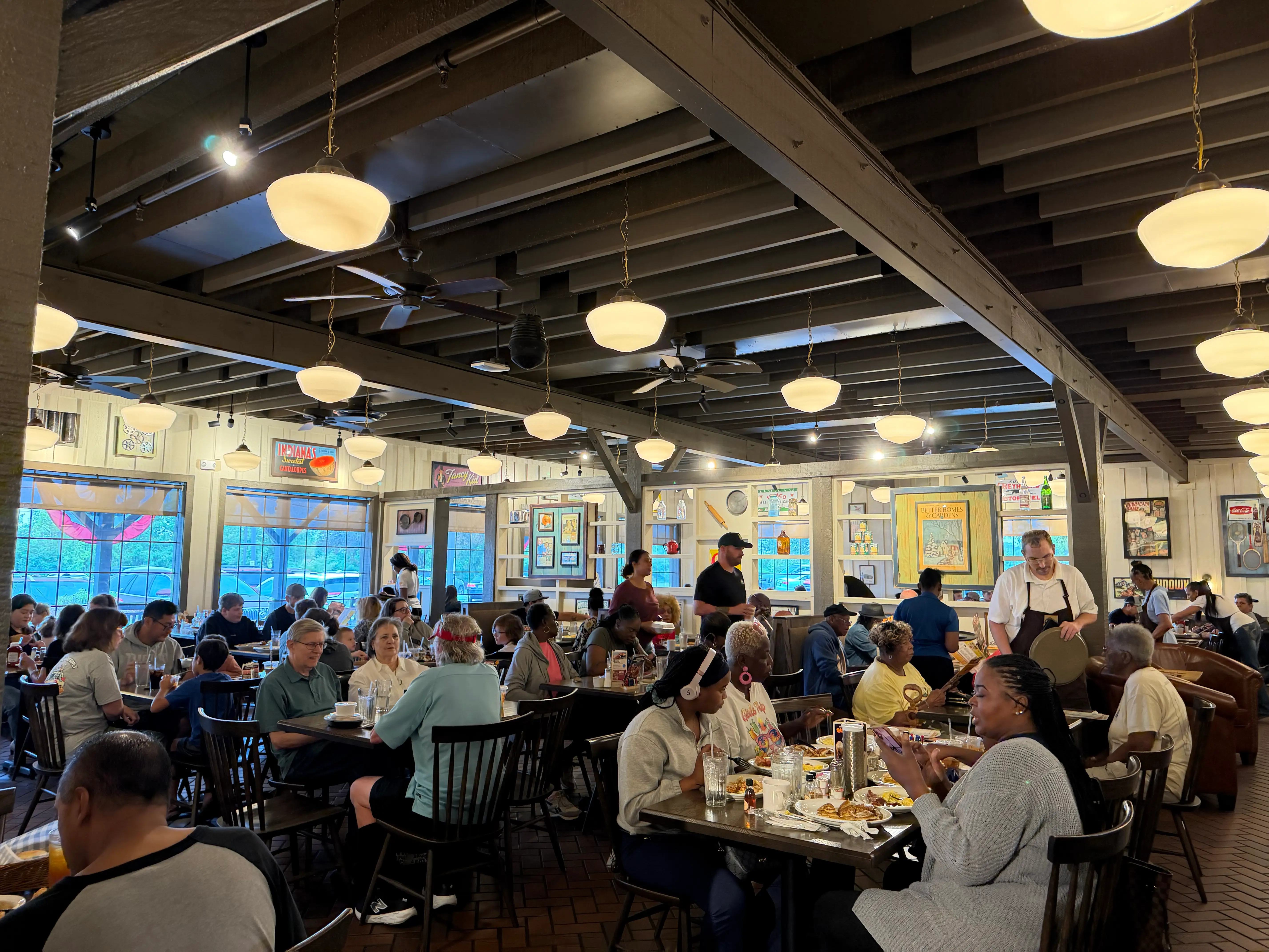 Interior of Cracker Barrel restaurant, crowded, wood beam ceilings, brick-like floor