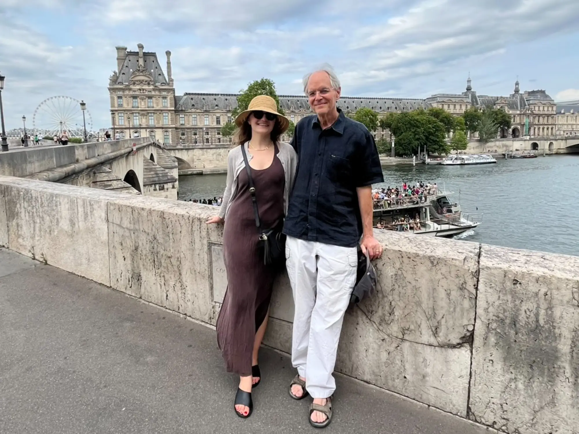 The writer and her father pose for a photo in front of the Seine River in Paris.