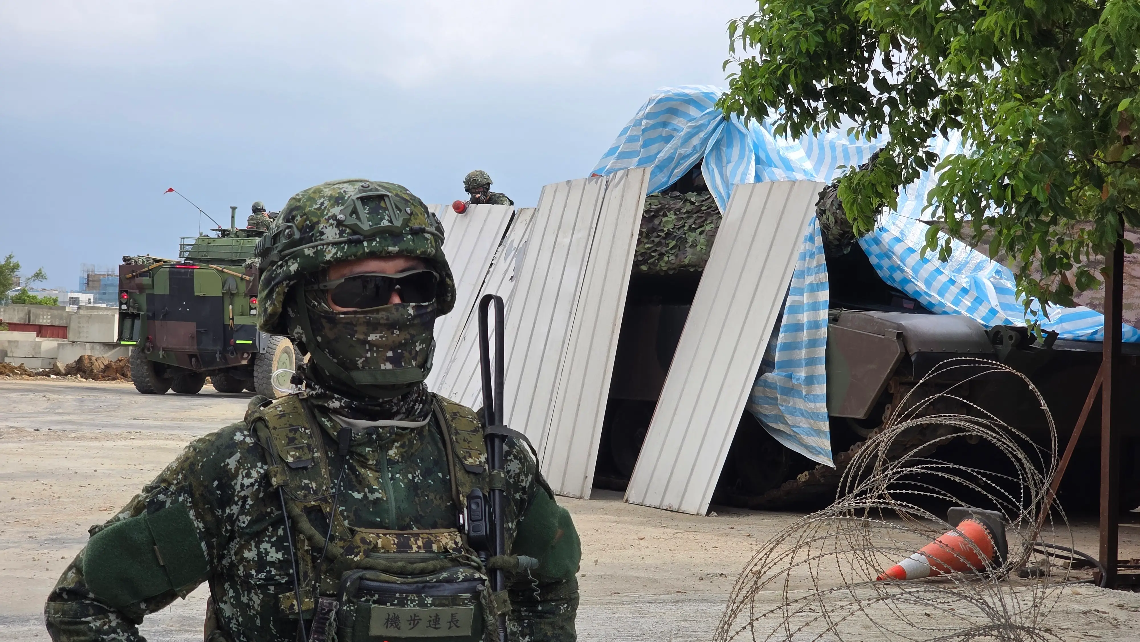 Taiwanese troops take position in a construction yard.