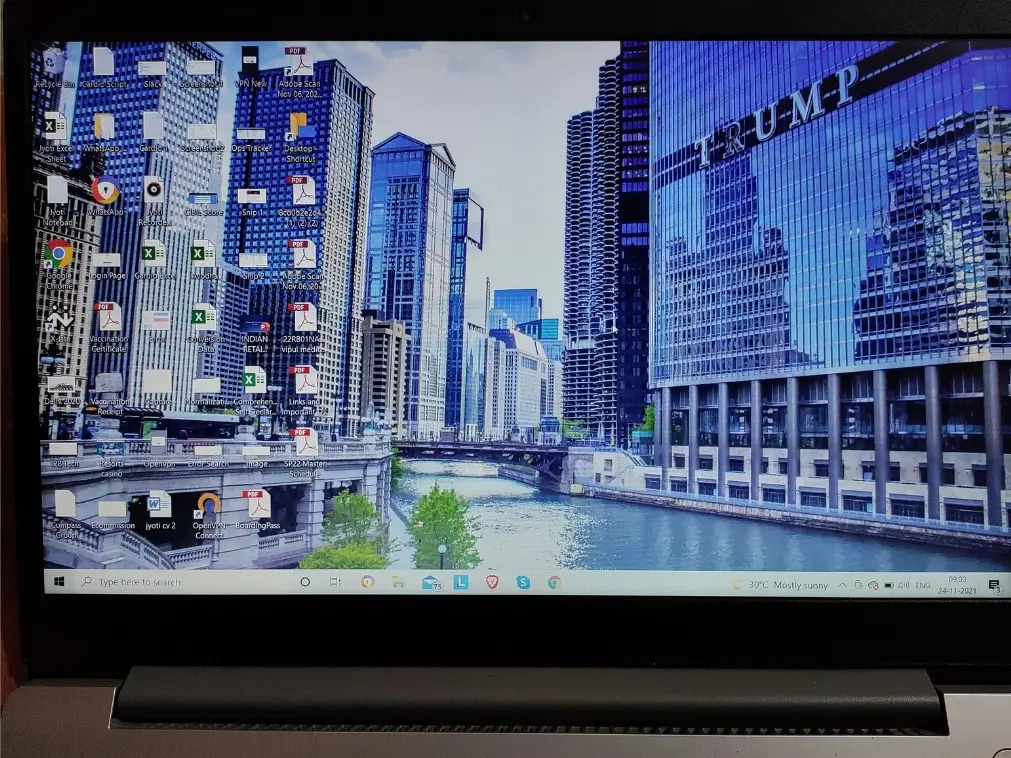 A computer laptop with wallpaper featuring the bridge overlooking the Chicago skyline.