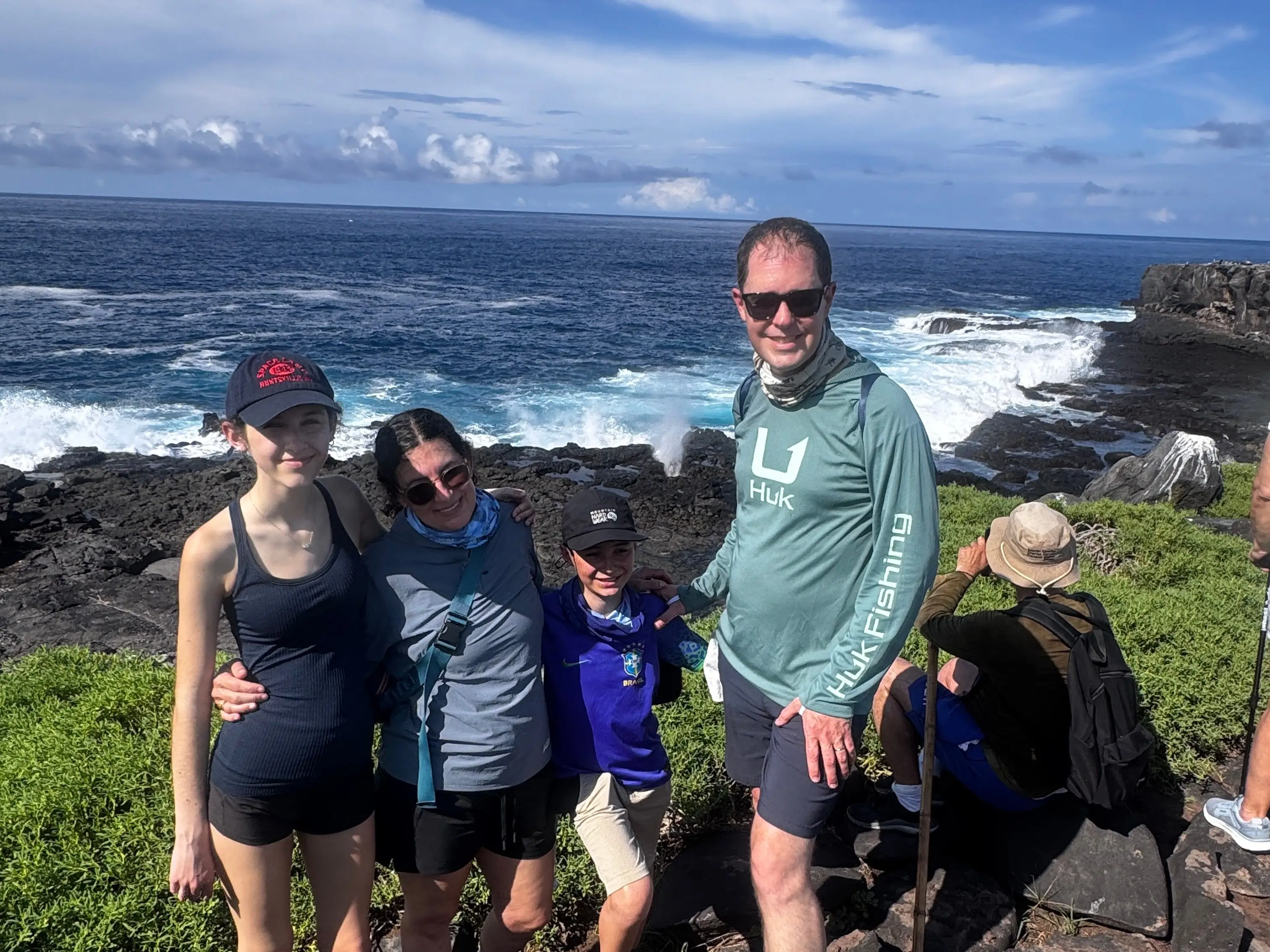 The author (second from left) posing on the beach while visiting the Galapagos Islands.