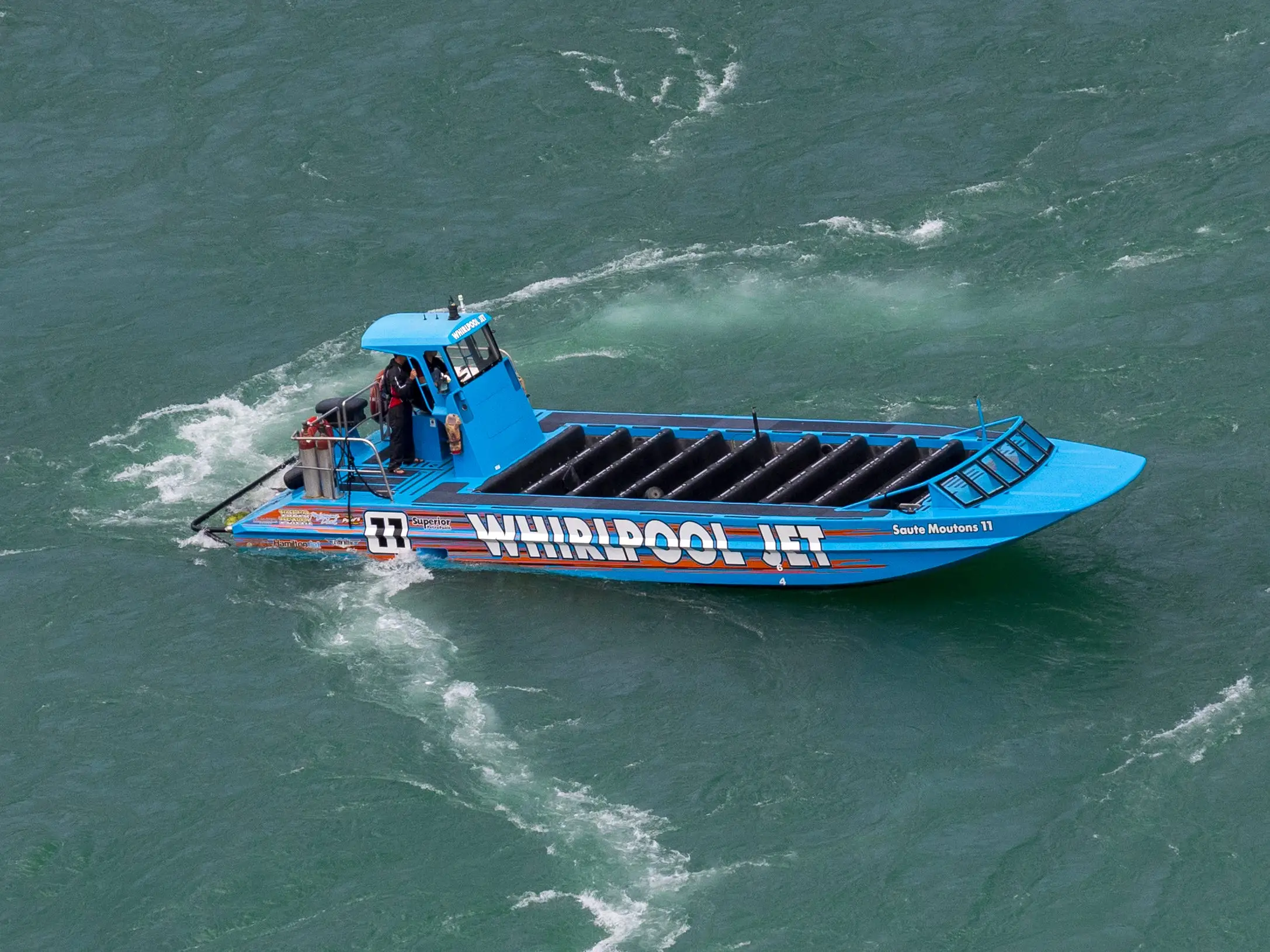 A Whirlpool Jet boat in the water.