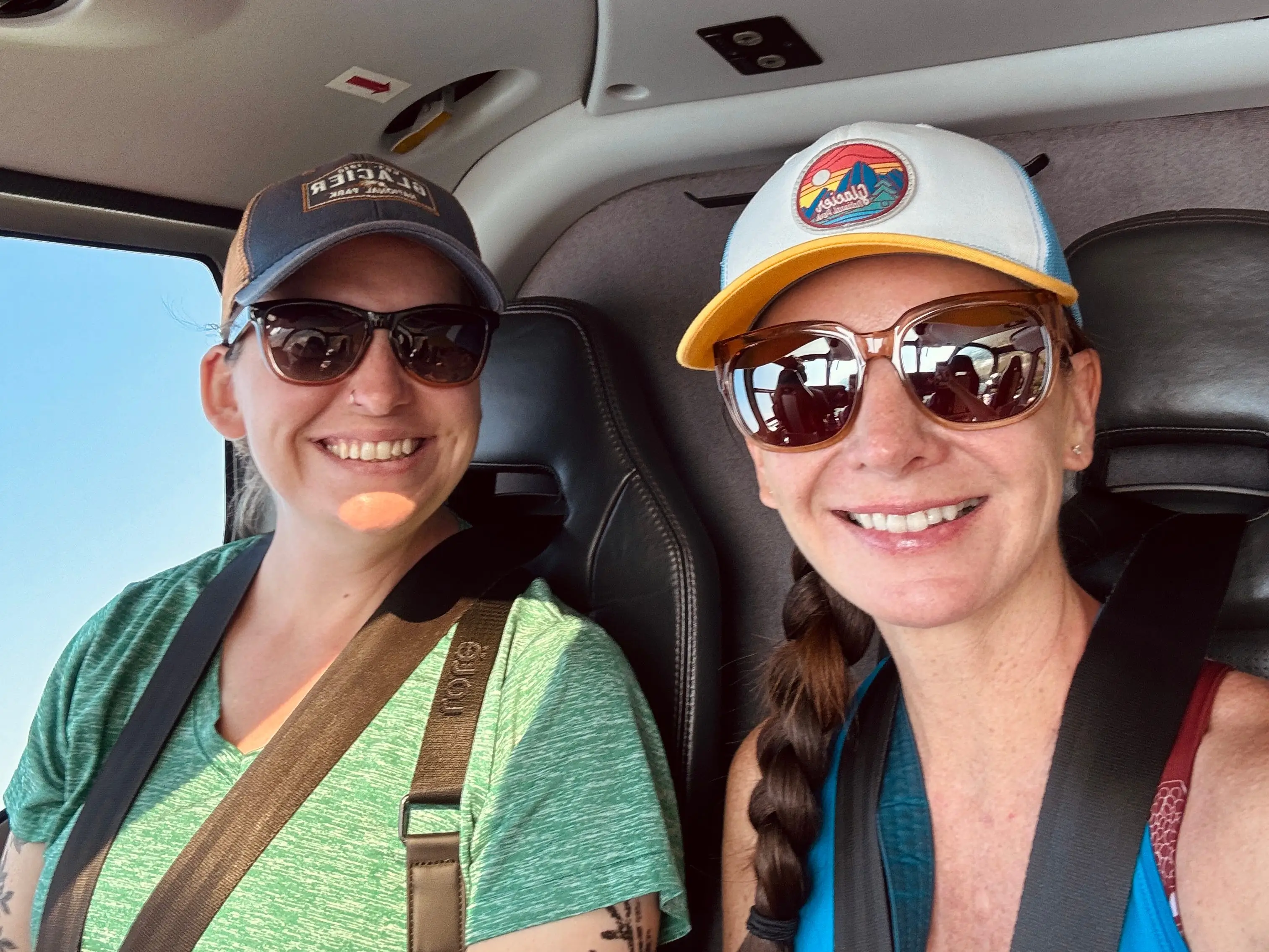 Melissa and her friend pose for a photo in a helicopter.