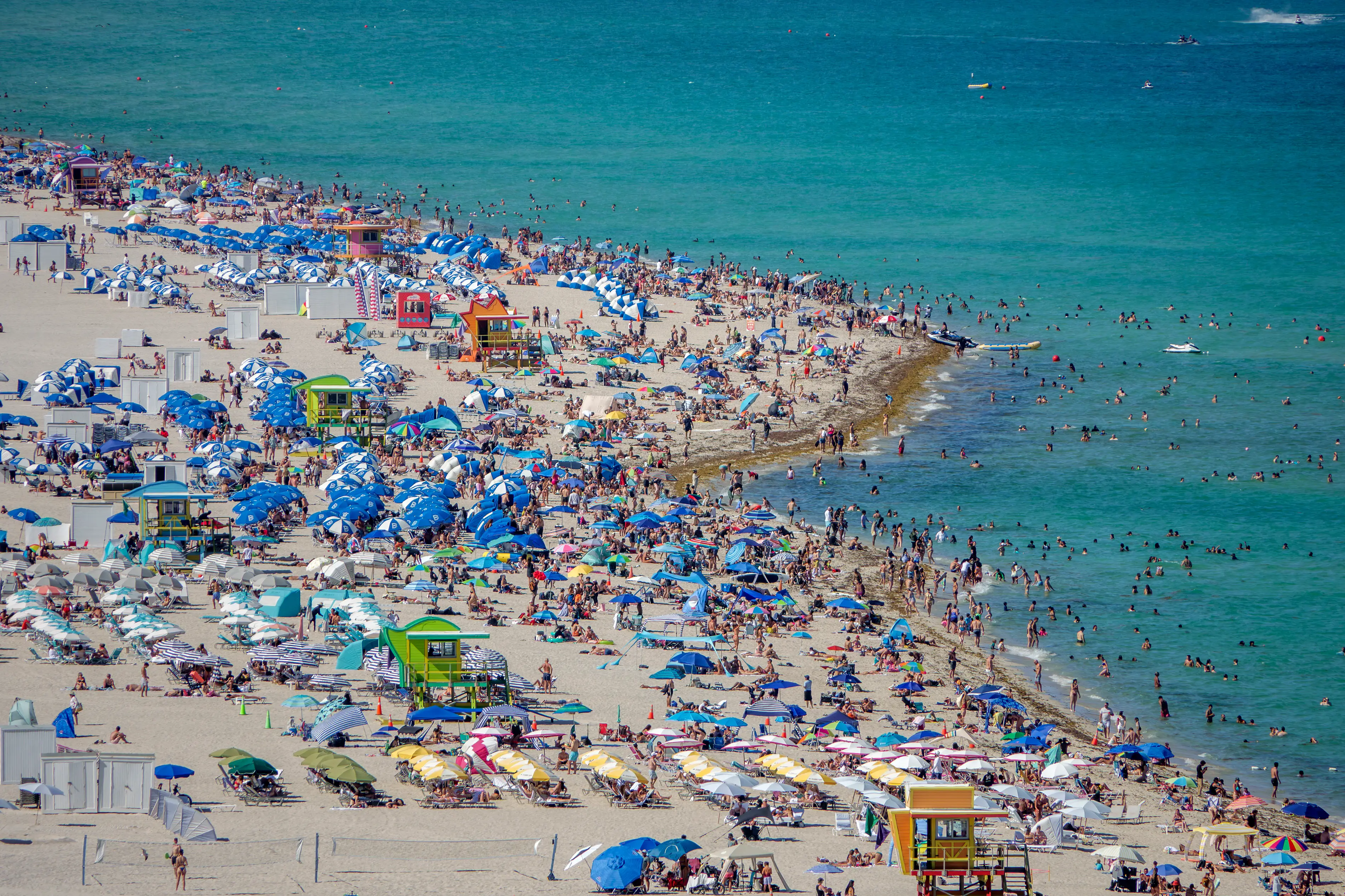 Miami Beach covered with beachgoers, umbrellas