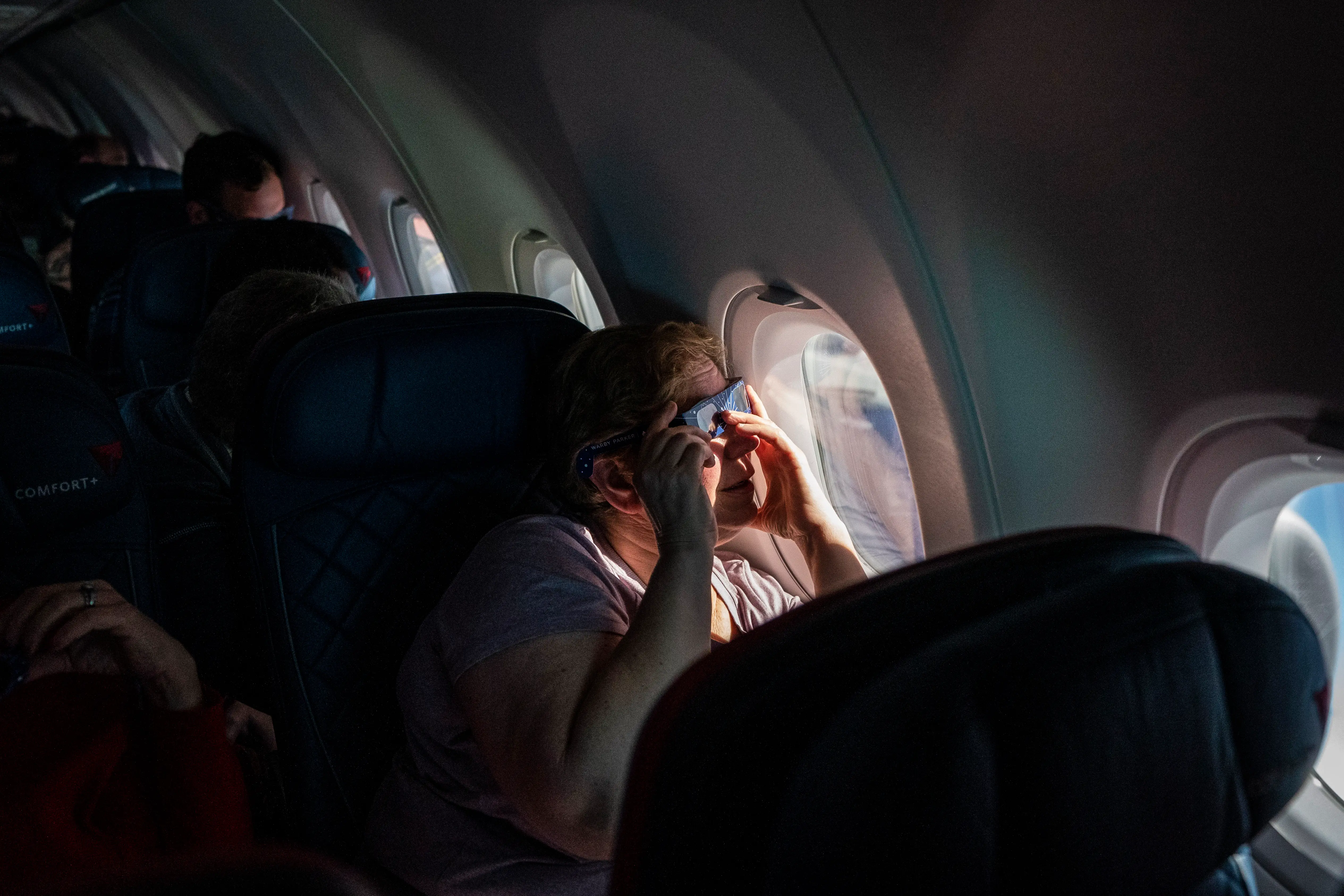 A person watching the solar eclipse from a Delta flight.