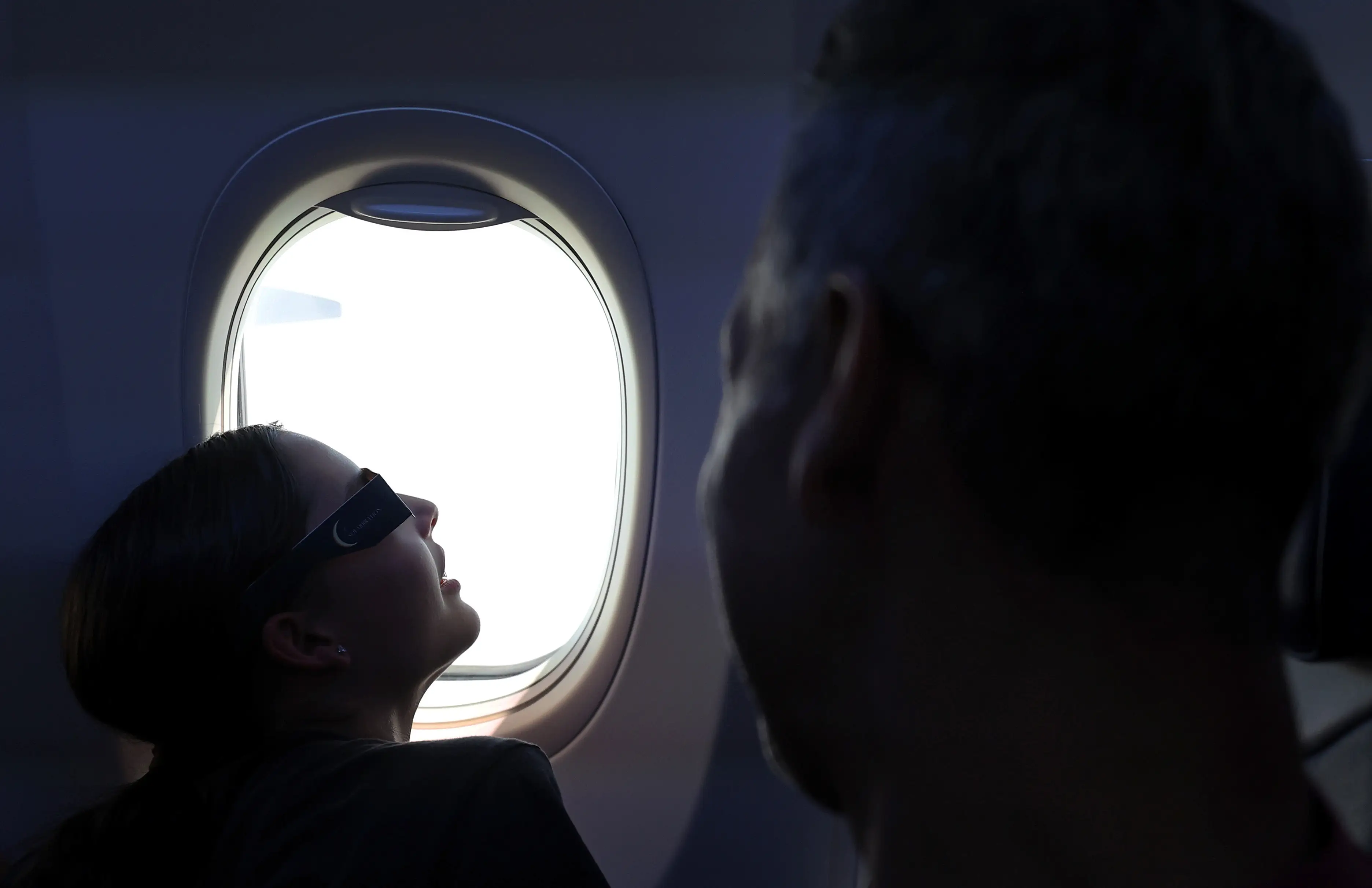 People on Southwest flight look at eclipse.