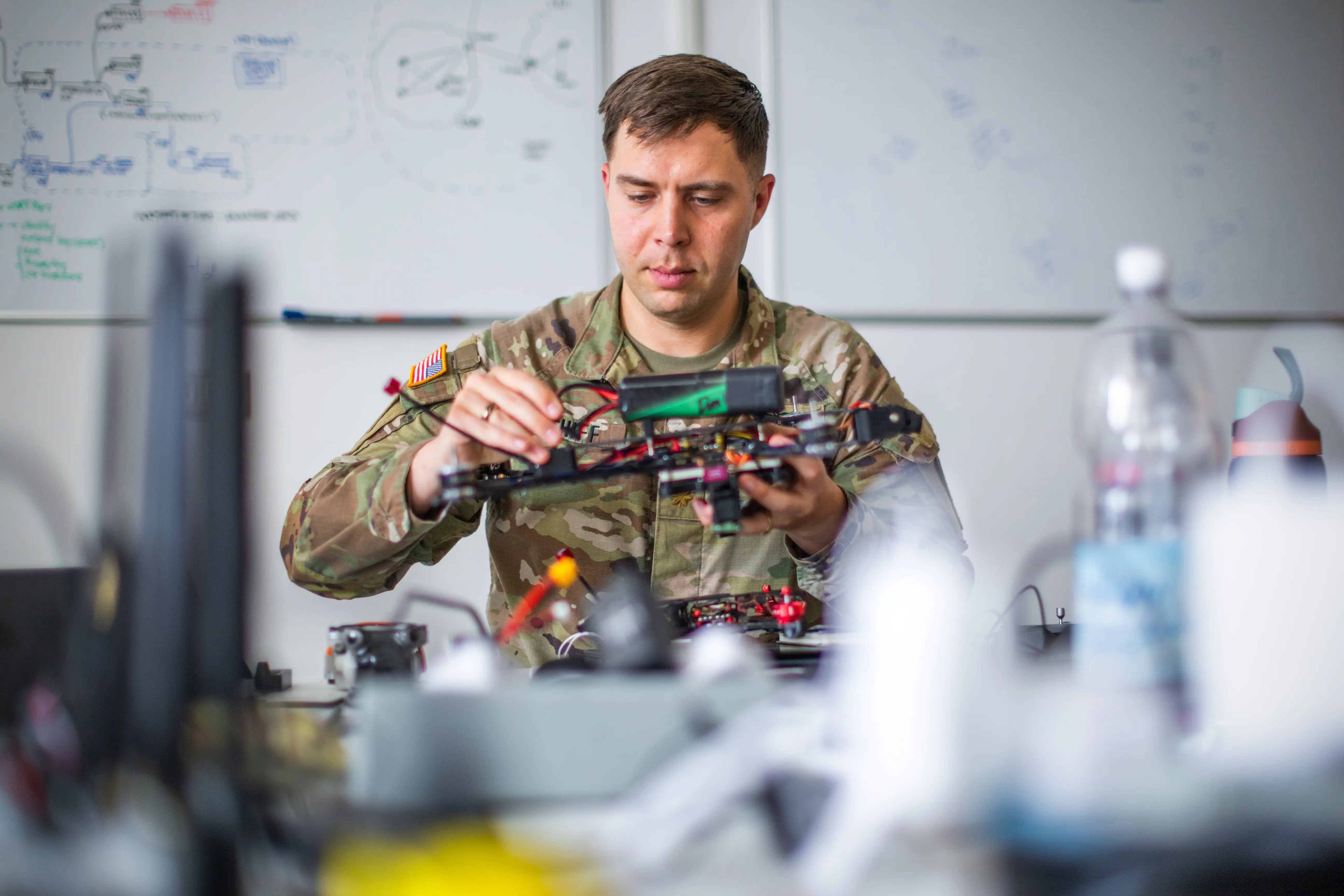 A US soldier holds a drone.