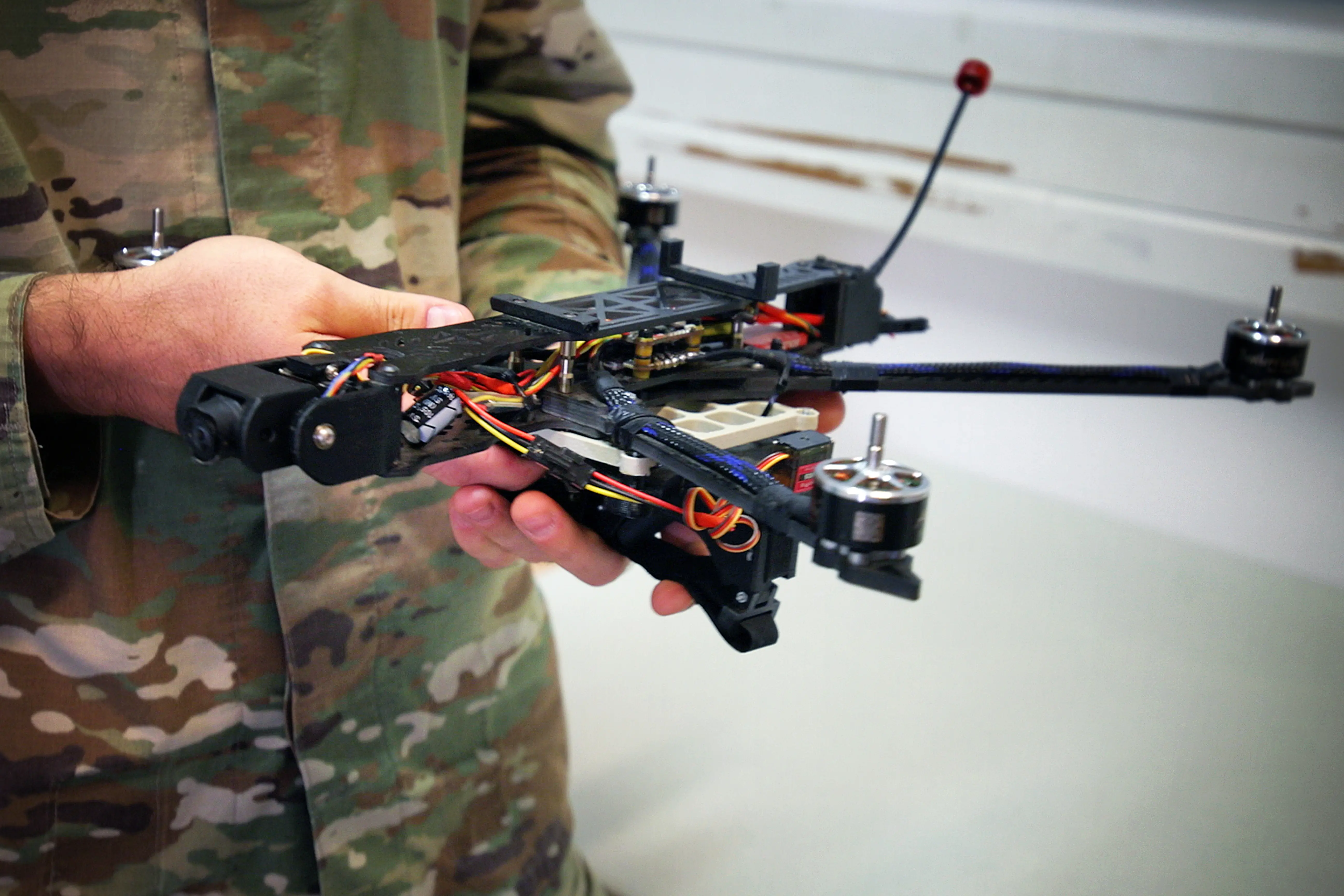 A NATO soldier holds a drone.