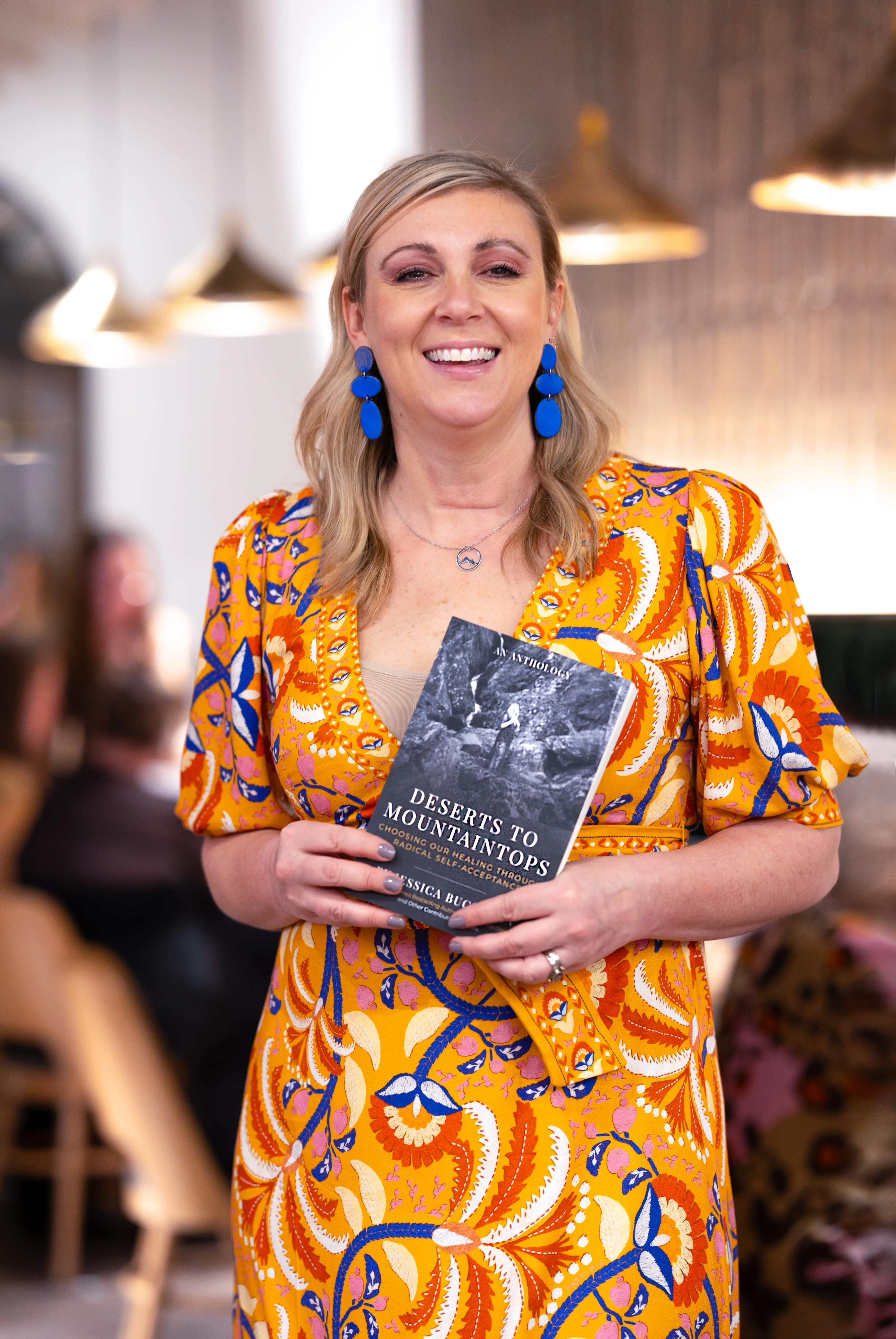 Jessica Buchanan is holding a copy of her book 