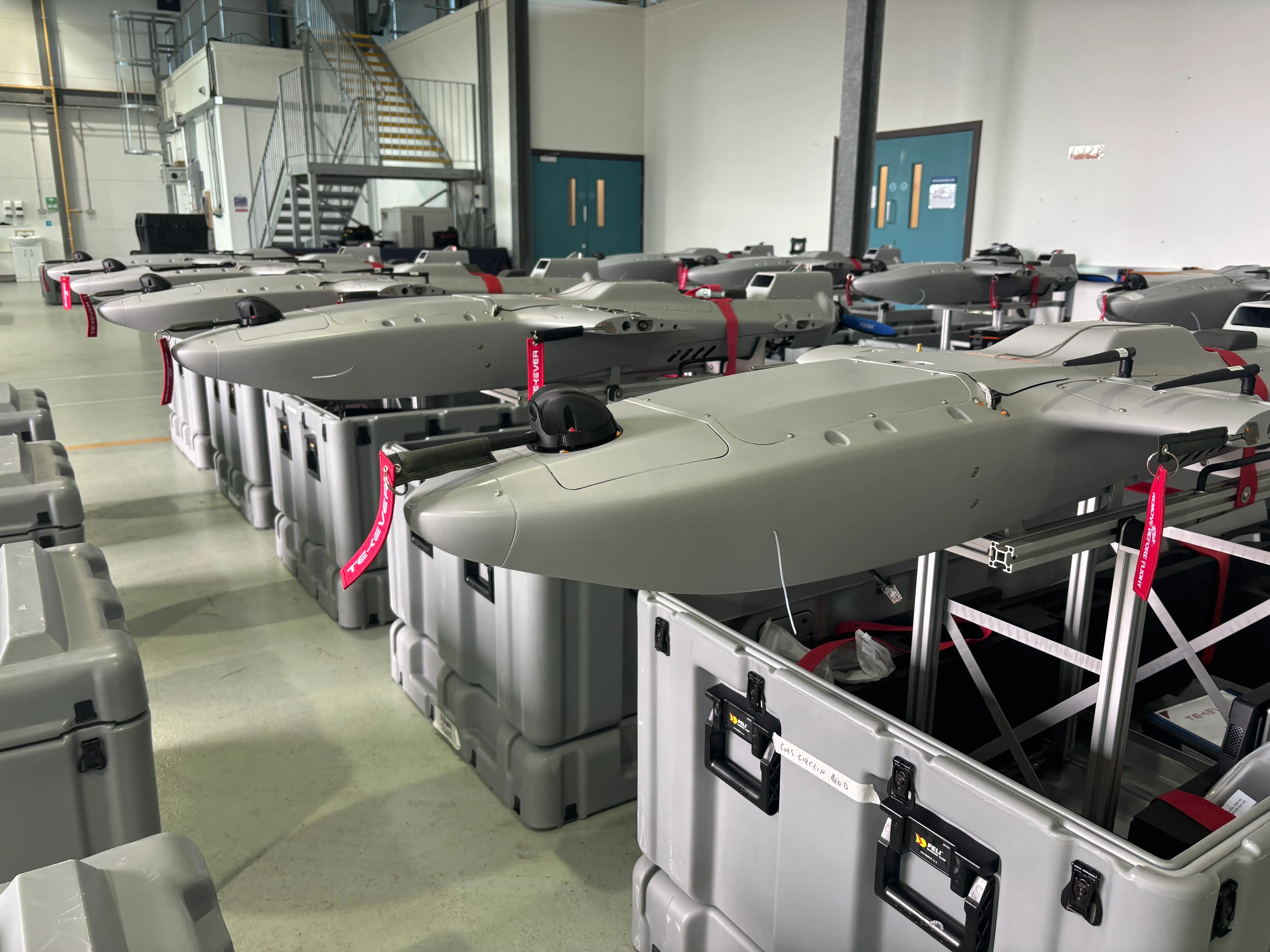 Drones are packaged into boxes at a factory.
