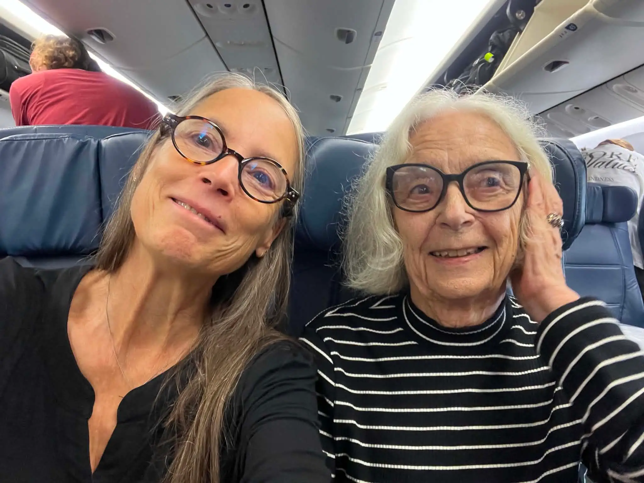 Kate Yourke, left, and her mom, Electra Yourke, right, on a plane.