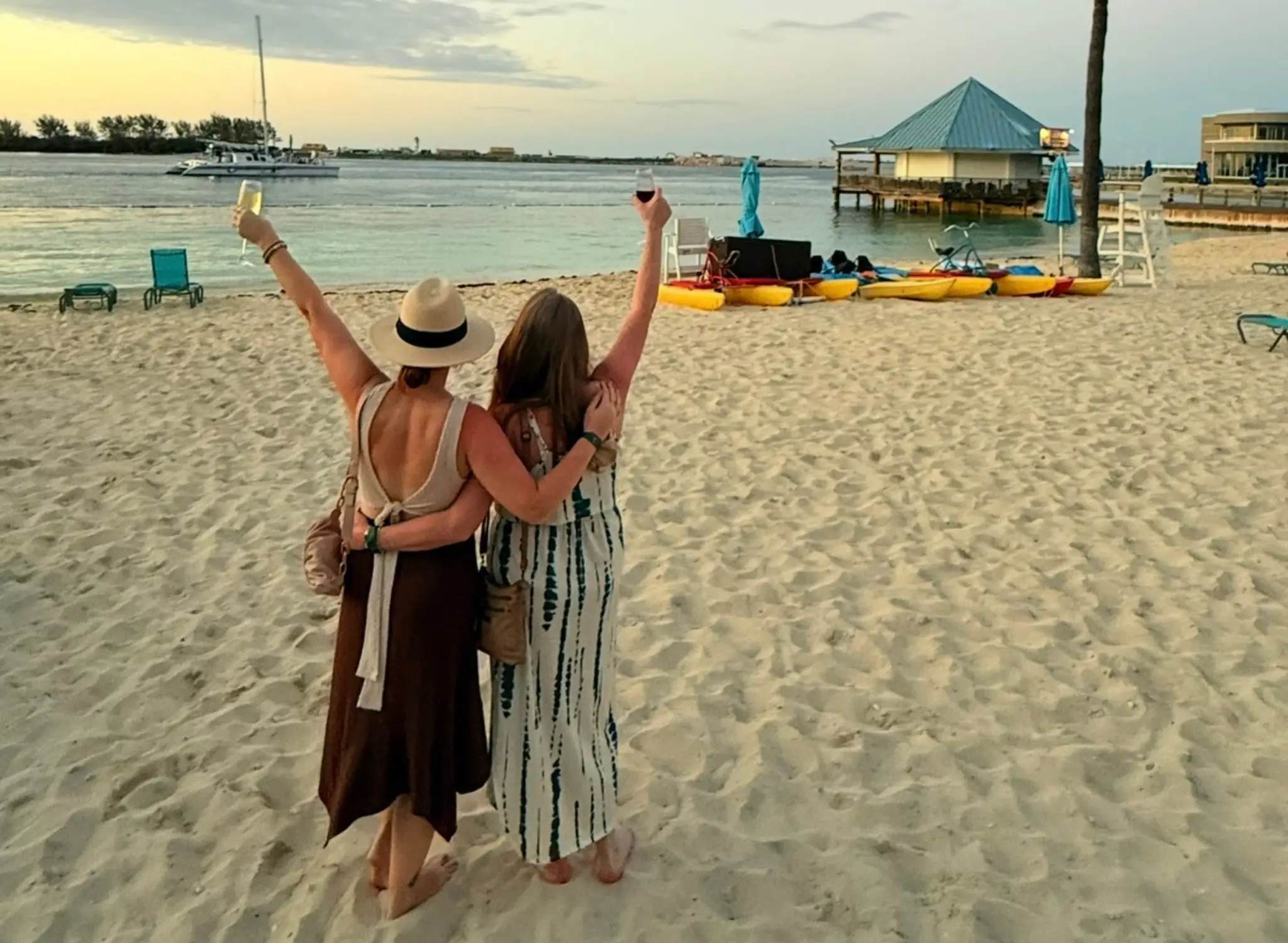 The author and her mother enjoy wine on a beach during a trip to Curaçao.