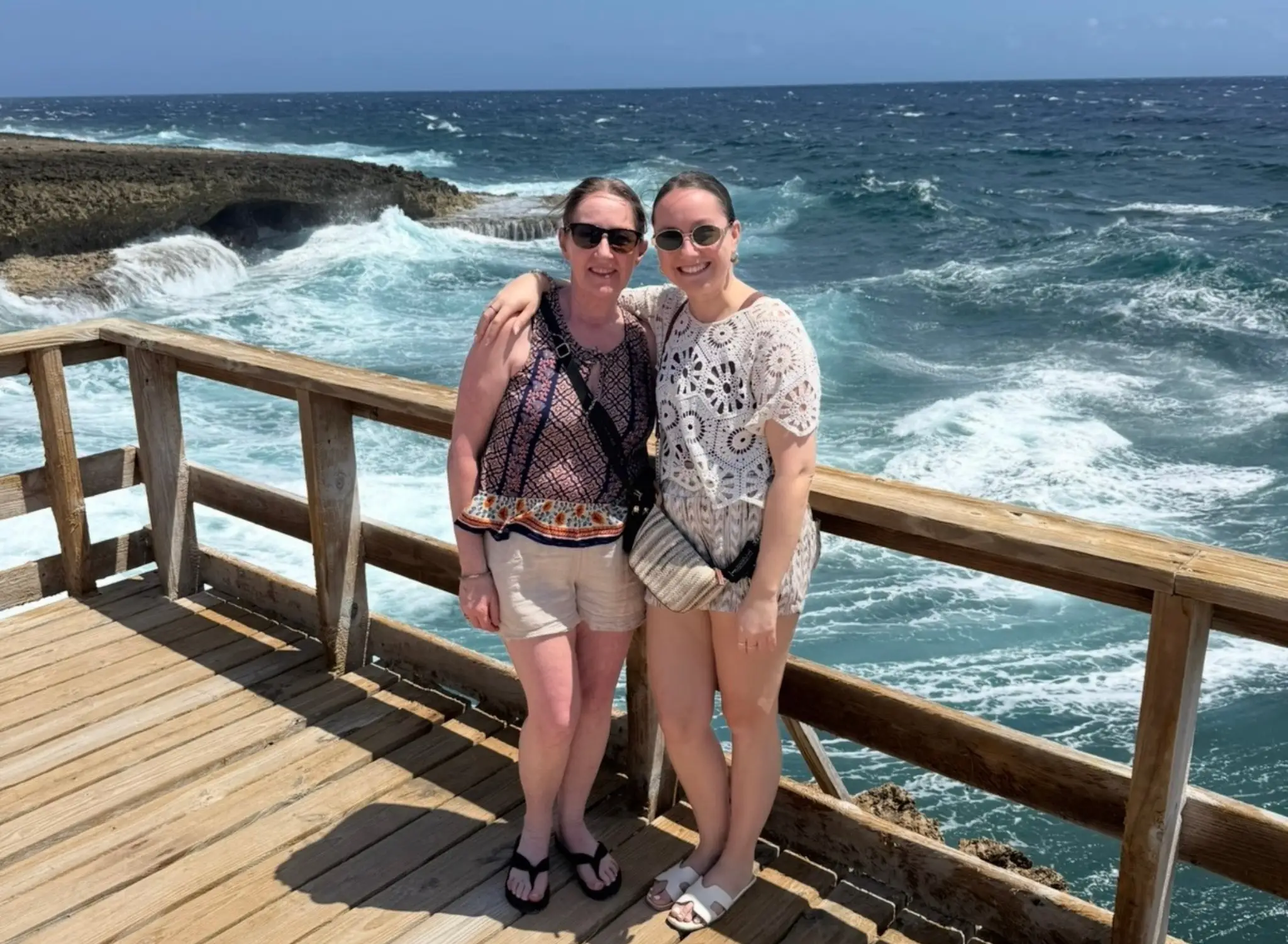 The author and her mother pos on a deck over the water.