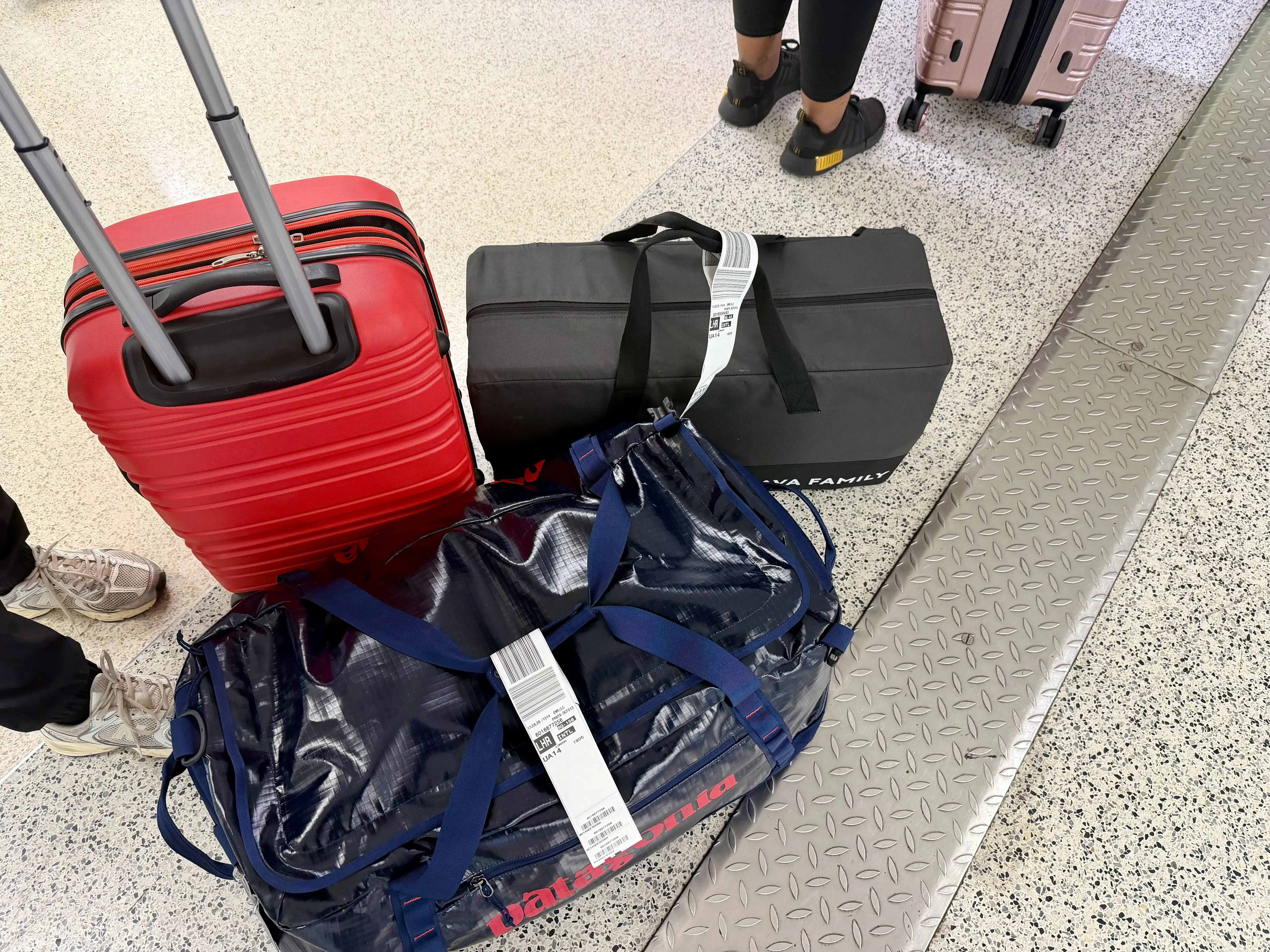 The author's blue Patagonia duffle bag on the floor of the airport.