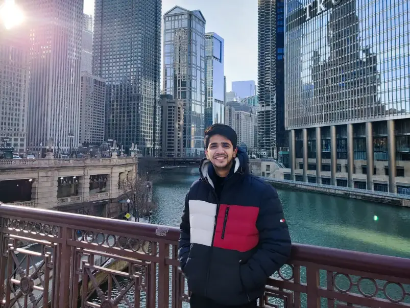 A man standing by a bridge in Chicago.