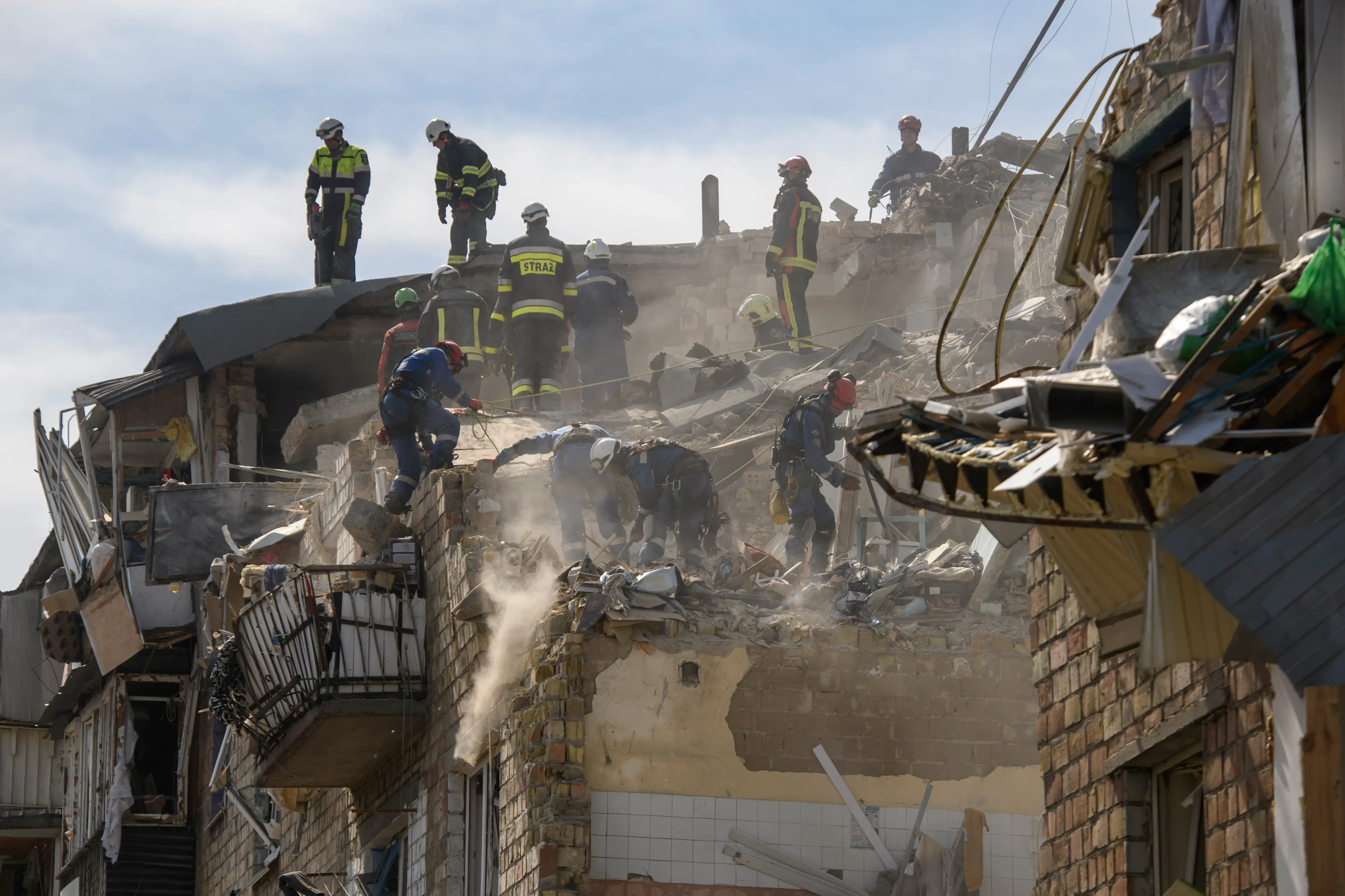Rescue workers at the site of an attack in Ukraine that involved KN-23 missiles and drones.