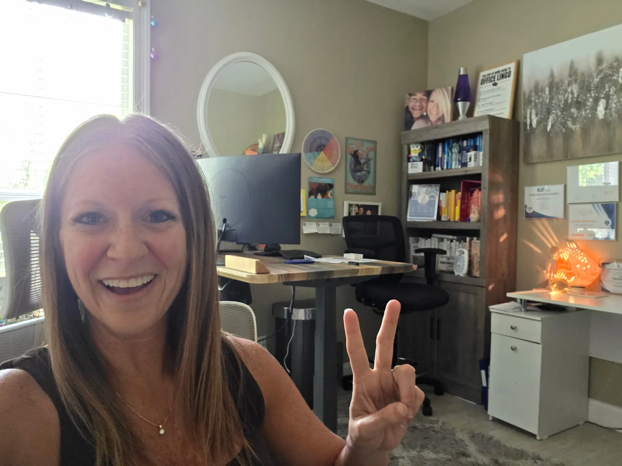 Brittany Blackman in her home office. There's a fish lamp in the background and a window with natural light.