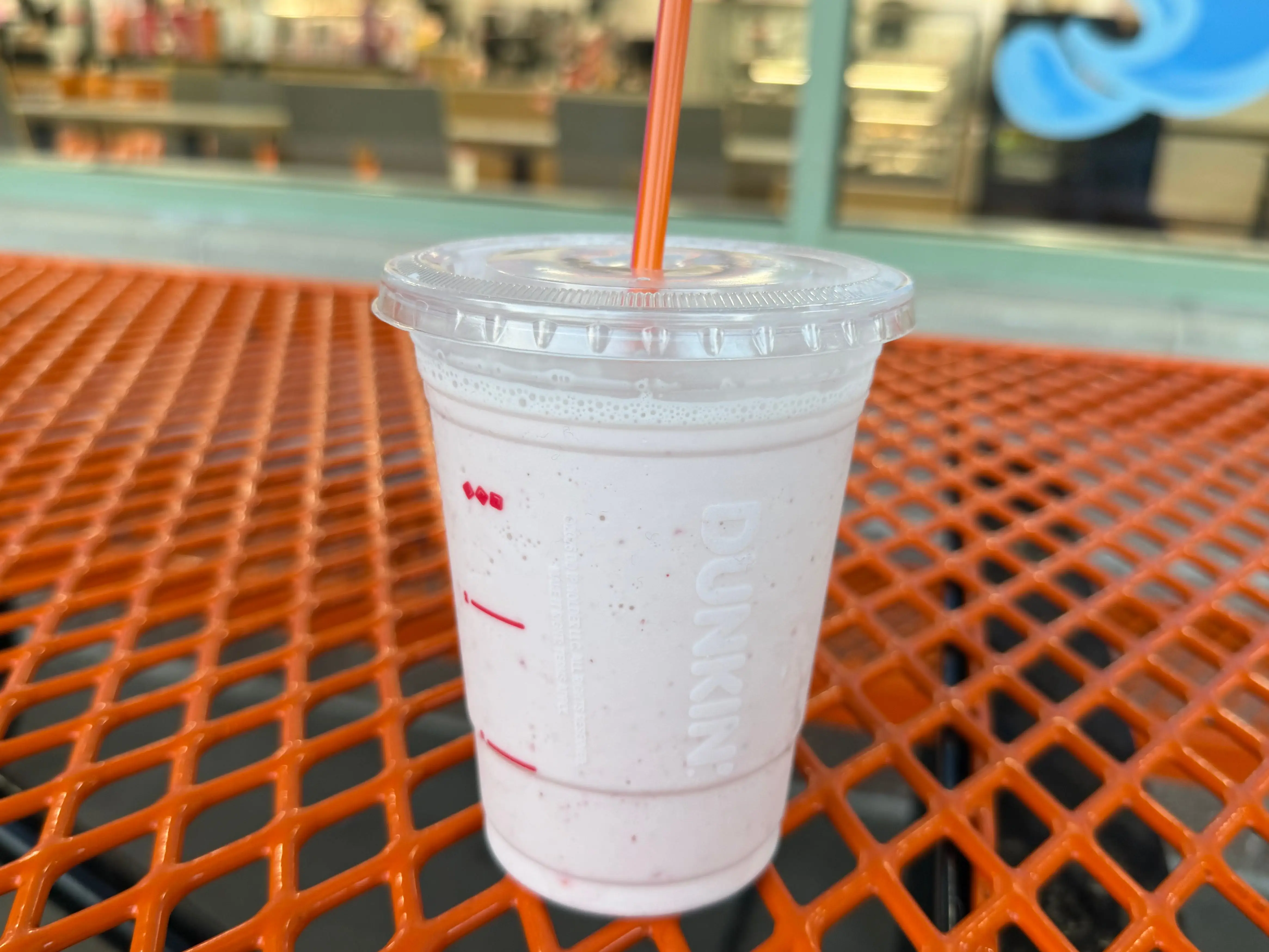 A strawberry milkshake from Baskin-Robbins in a Dunkin' cup.