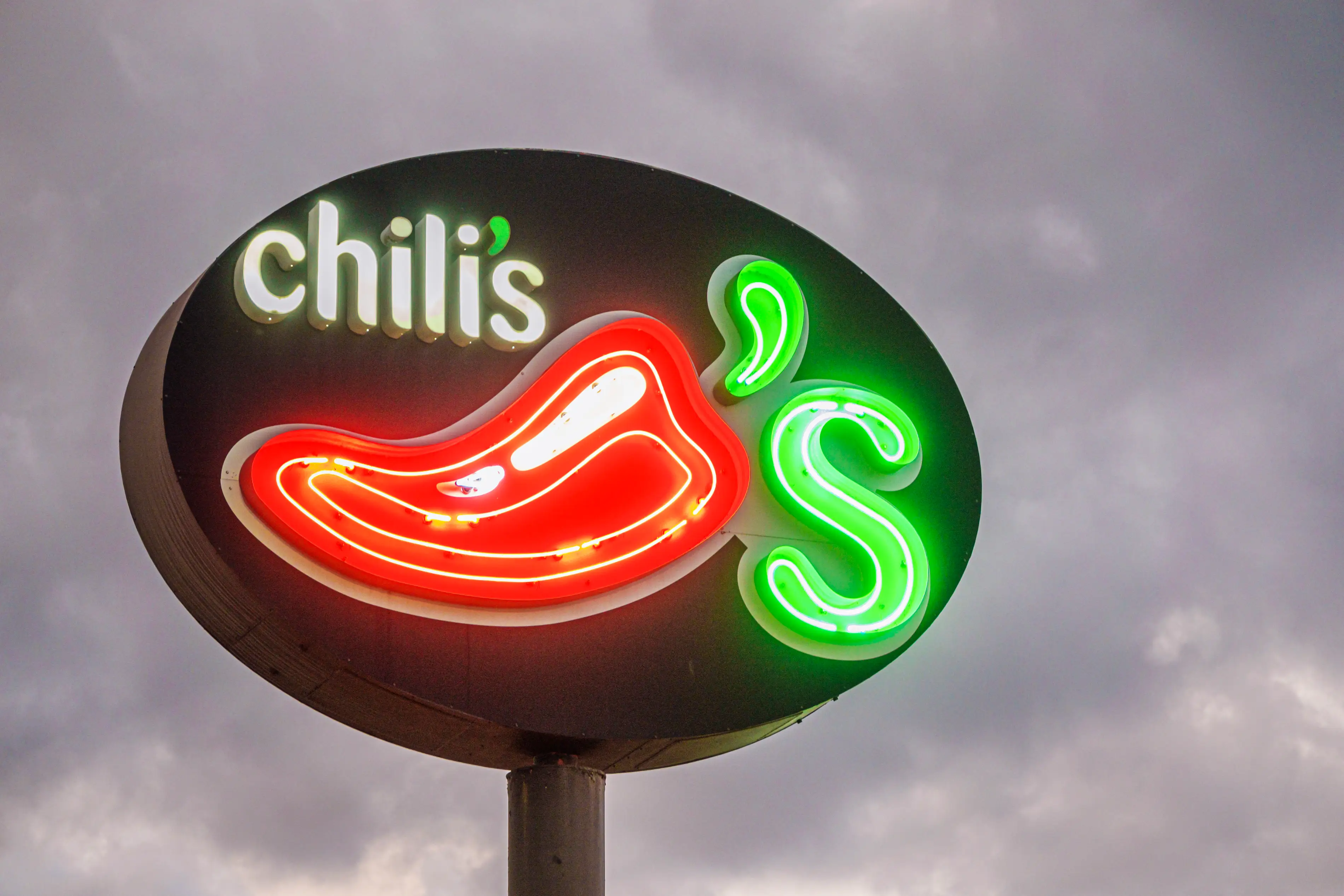 A neon sign with the Chili's restaurant logo
