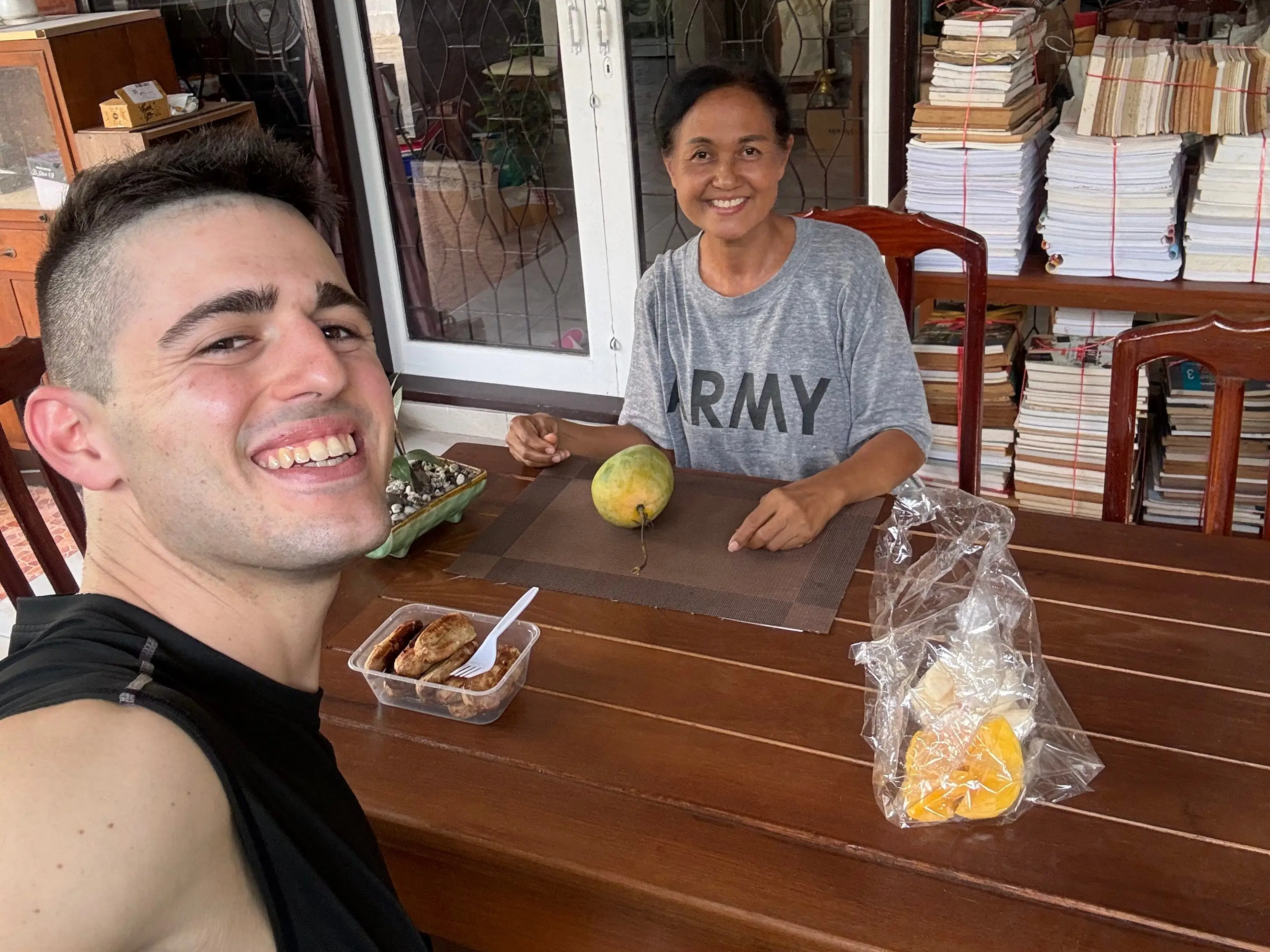 Man smiling with woman at dining table