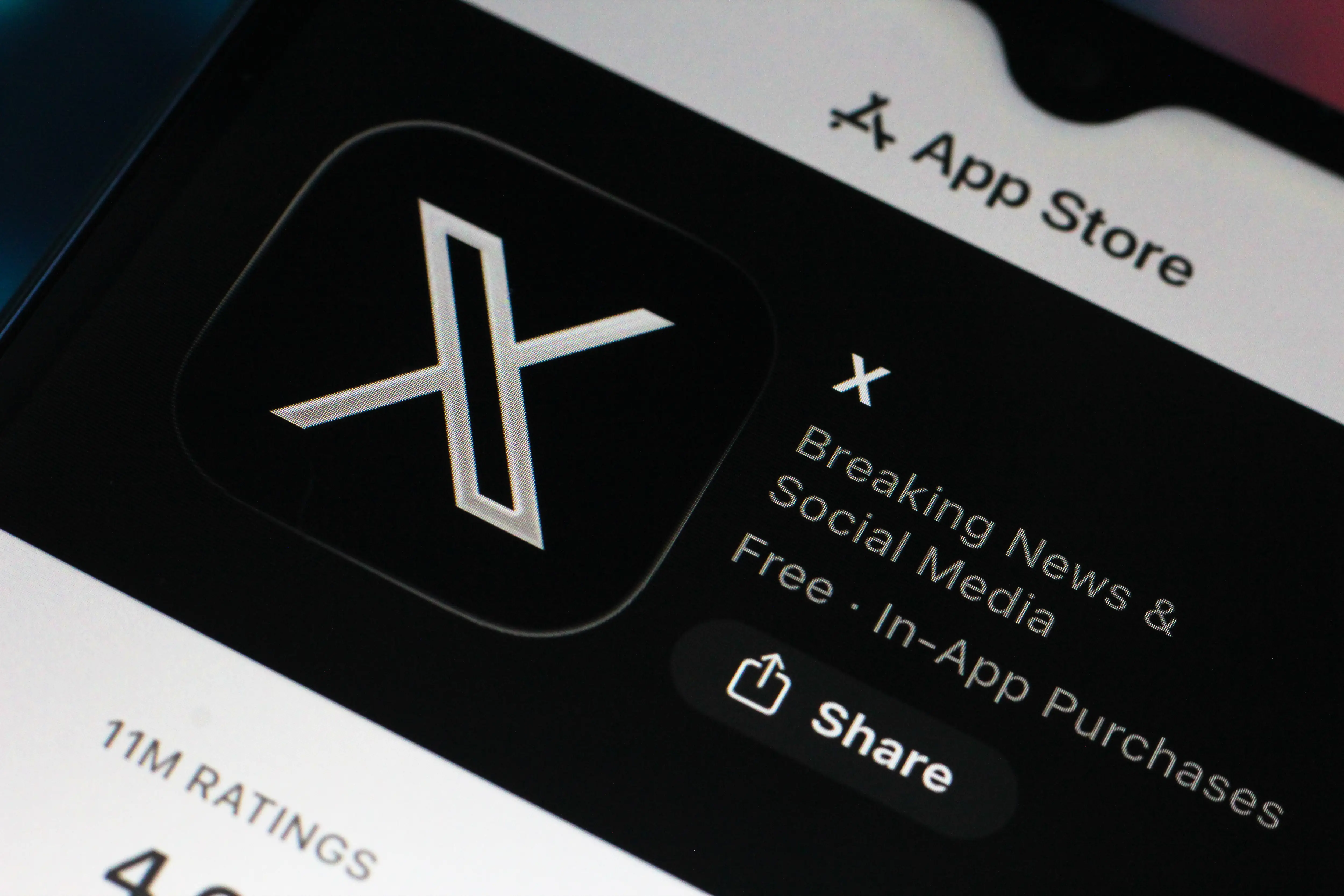 In this photo illustration, the X (Twitter) logo is seen displayed on a smartphone screen in the Apple app store.