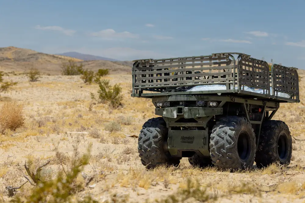 An uncrewed ground vehicle is parked in the desert.