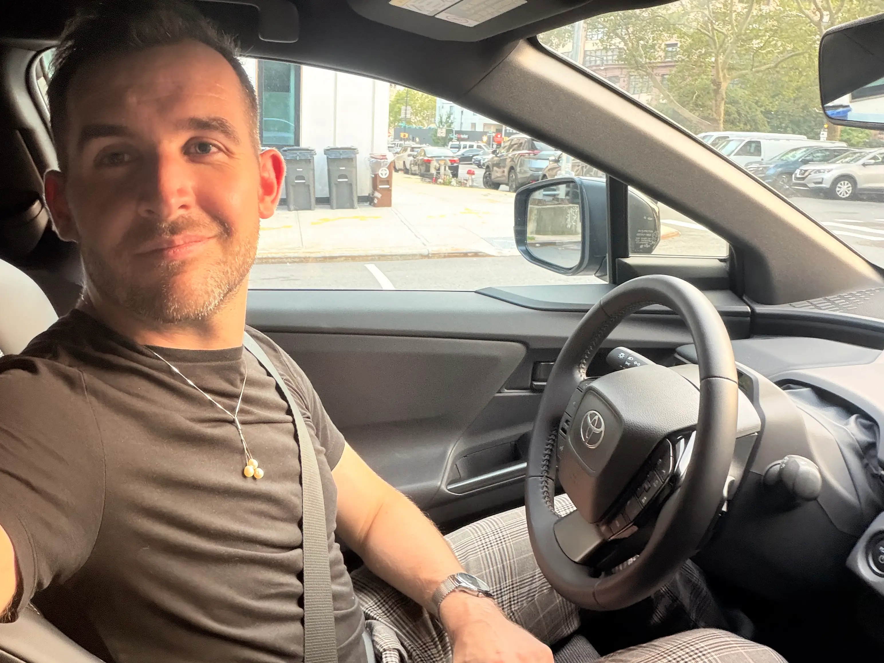 Business Insider's automotive reporter, Ben Shimkus, sits in the driver's seat of a 2026 Toyota bZ.
