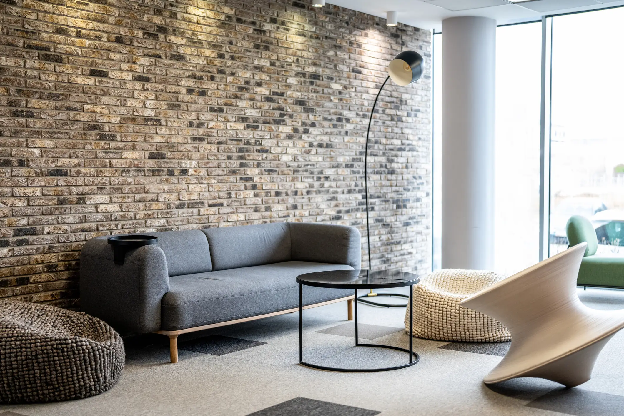 Room with brick wall, beanbags, modern couch