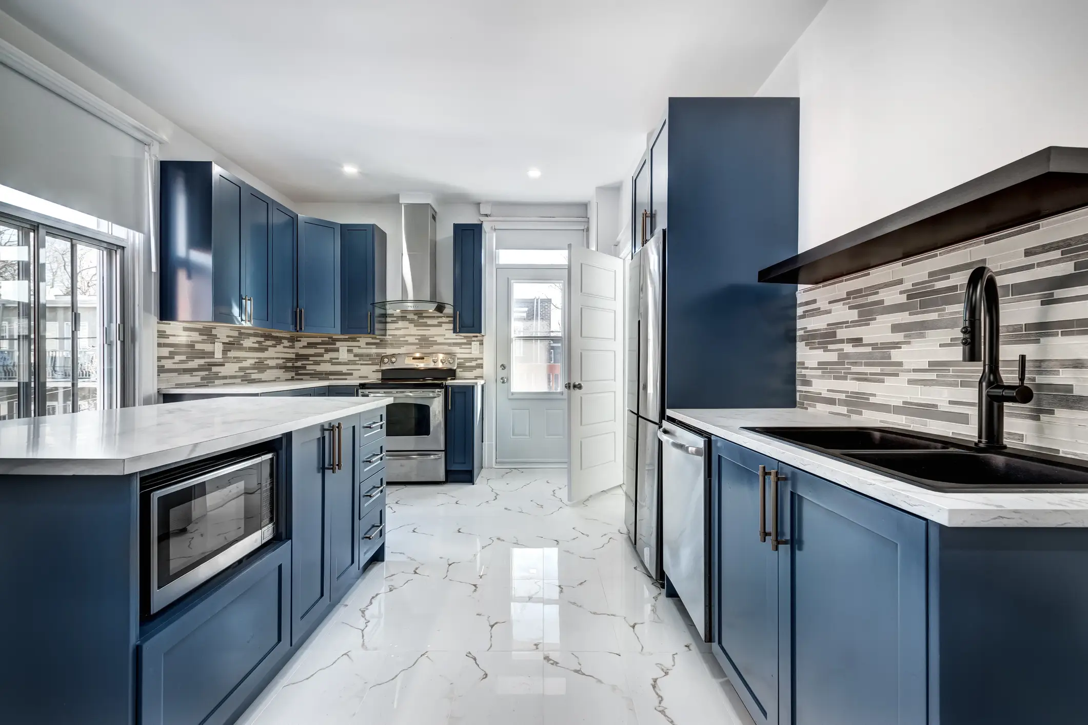 Kitchen with blue cabinets, marble-looking tile floor