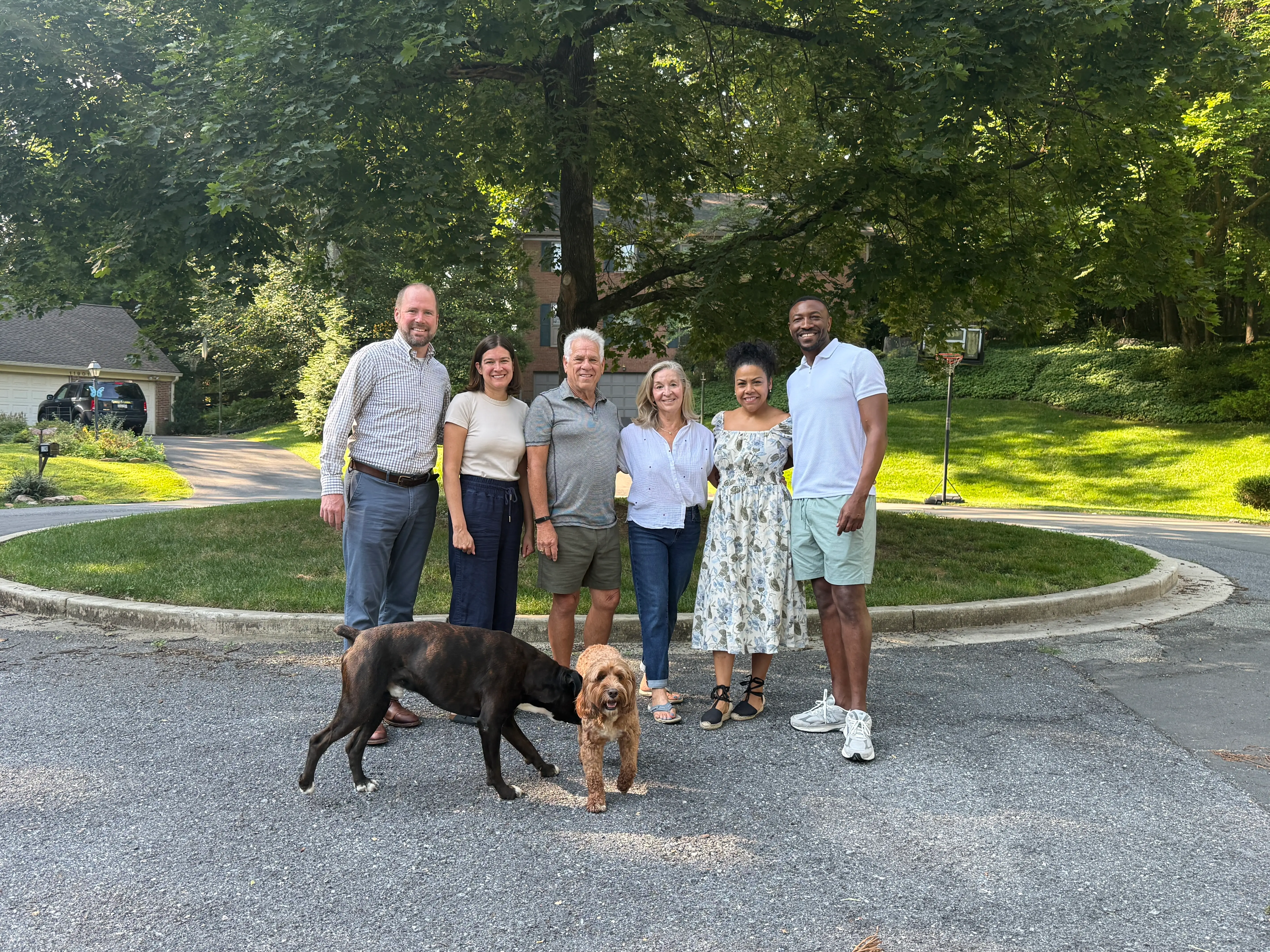 The writer, her husband, and their neighbors and dogs standing around their cul-de-sac.