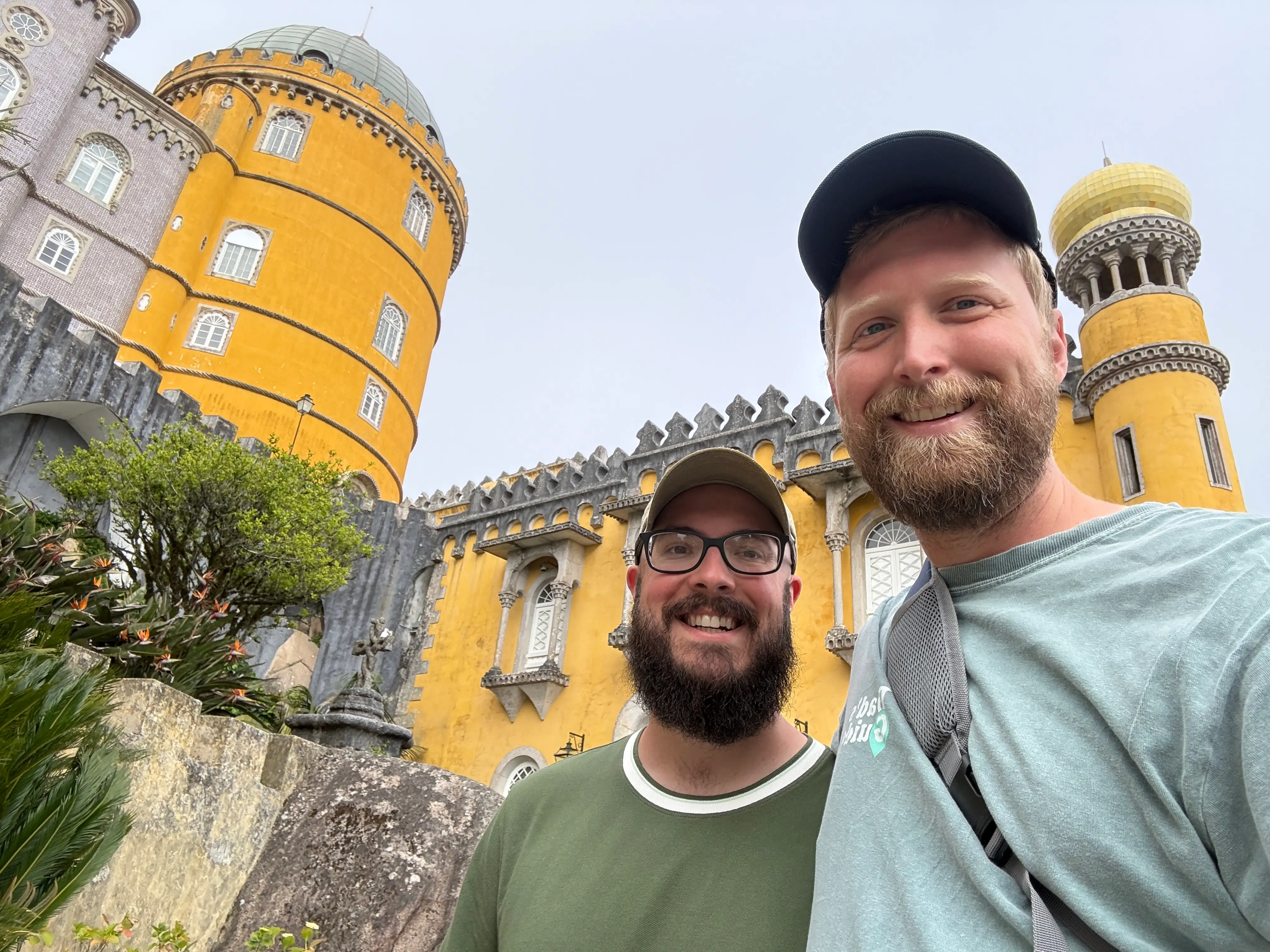 Two men smiling outside of Pena Palace