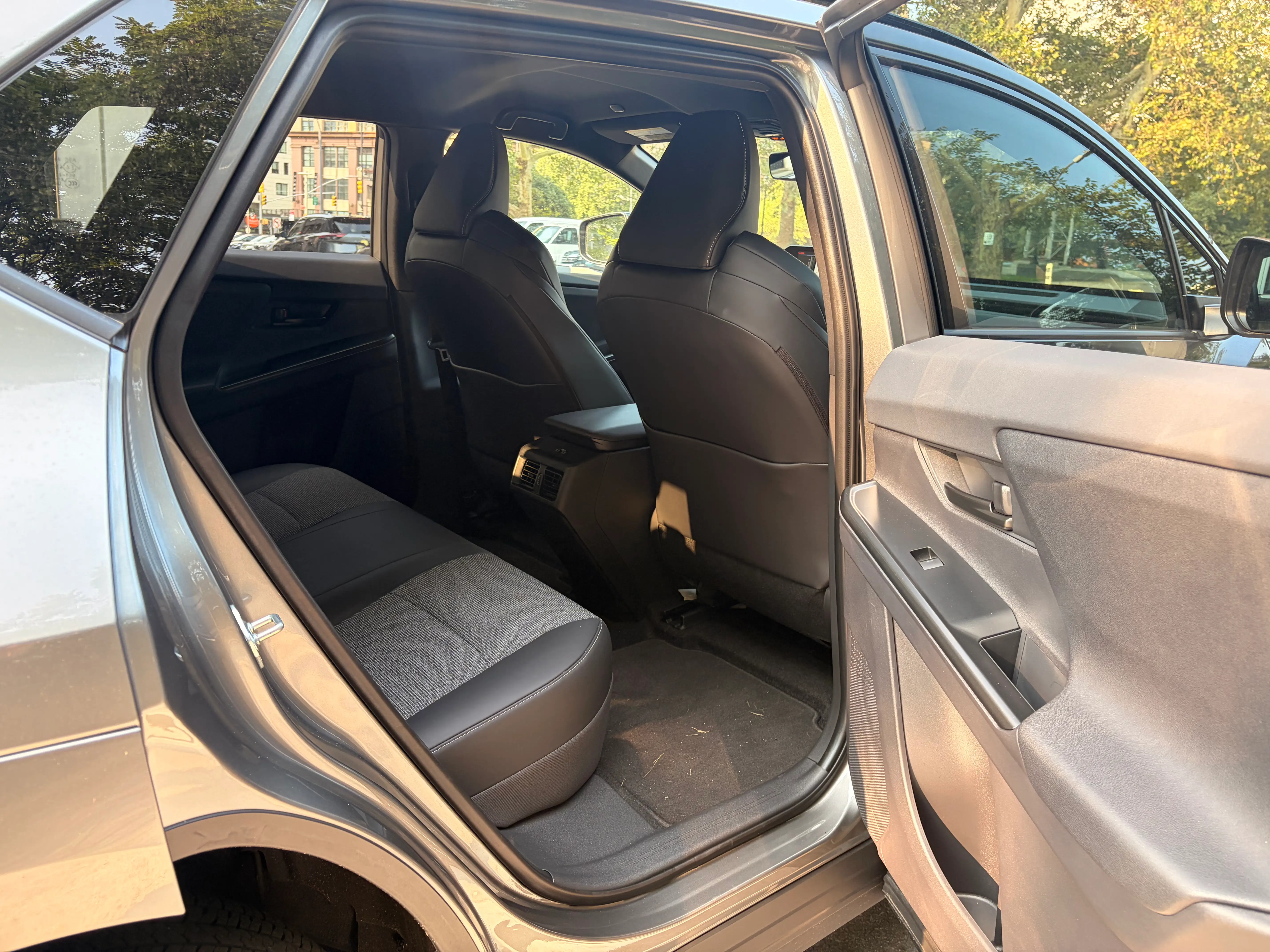 The passenger-side backseat door of a Toyota bZ is open.