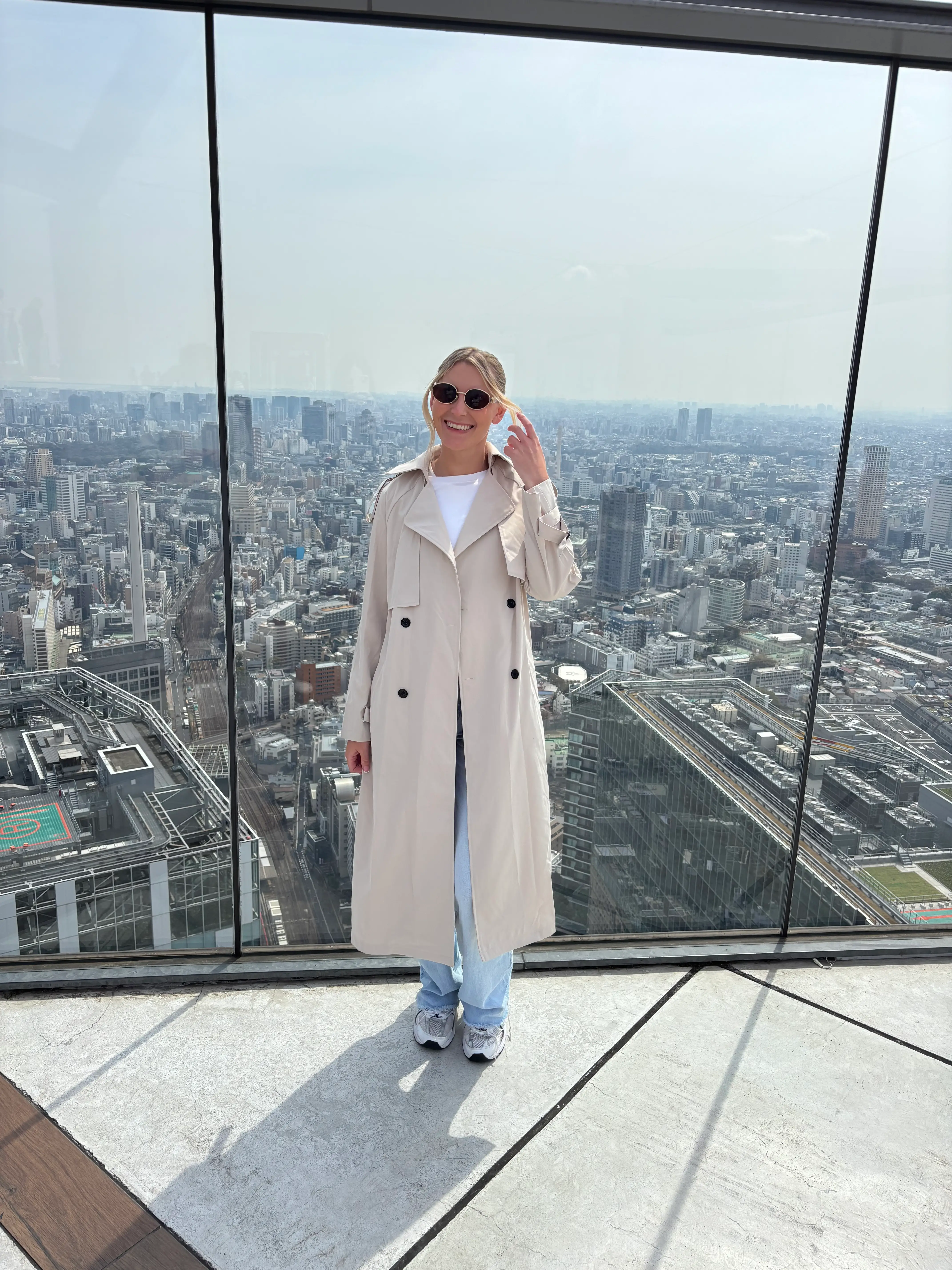 The author posing on an observation deck while traveling in Asia.