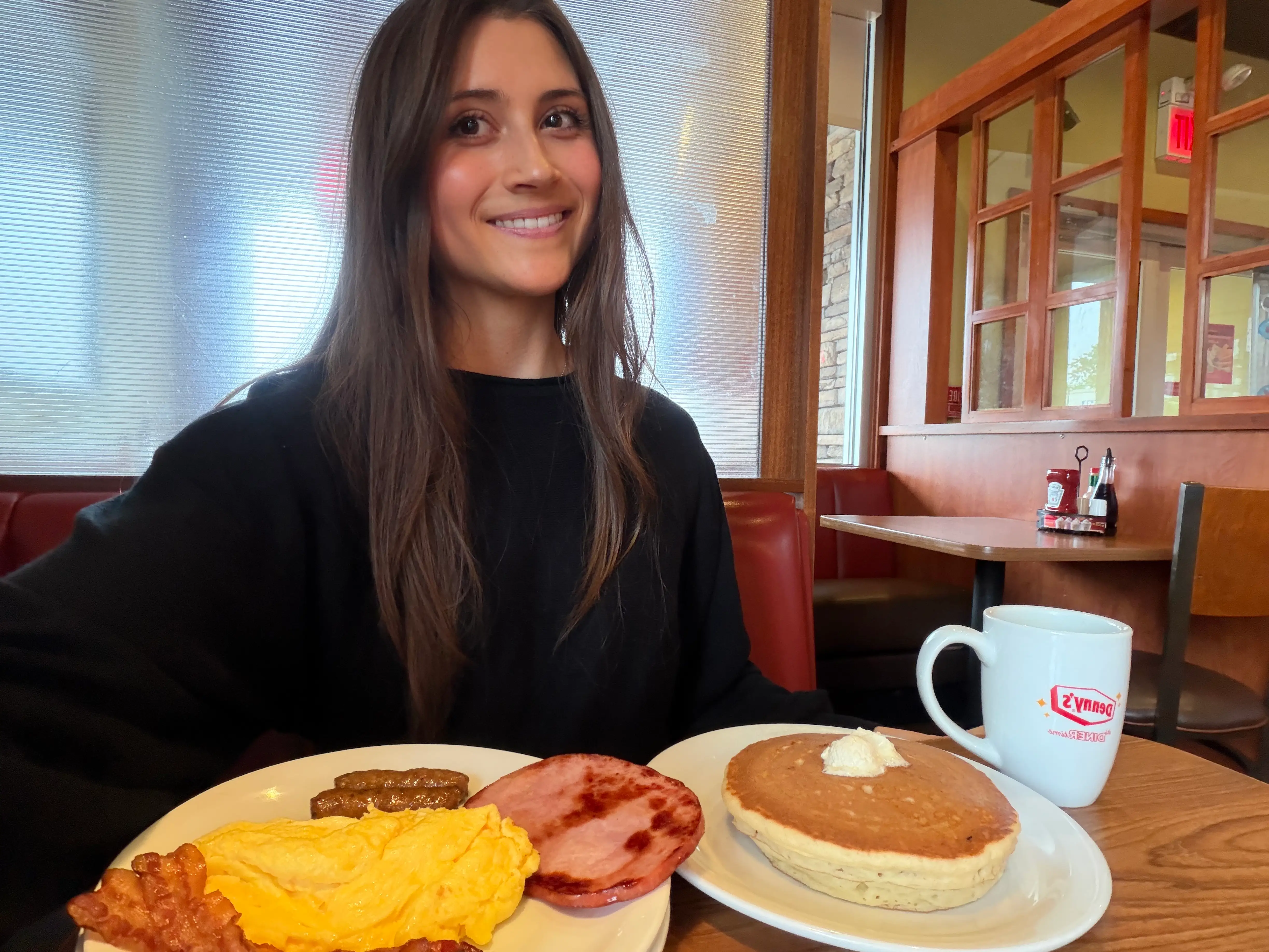 Woman smiling with a breakfast at Denny's