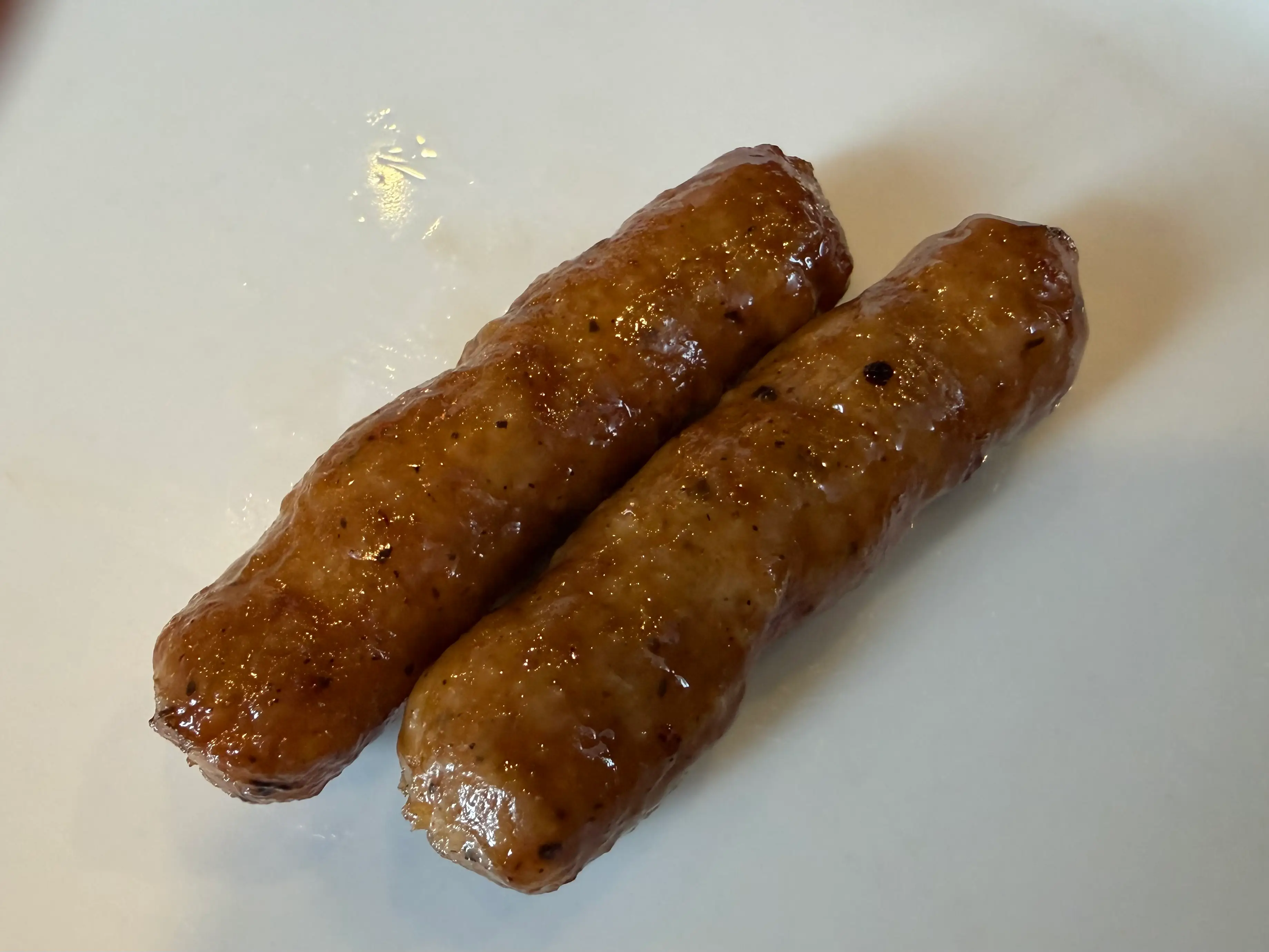 Two pieces of sausage on plate at Denny's