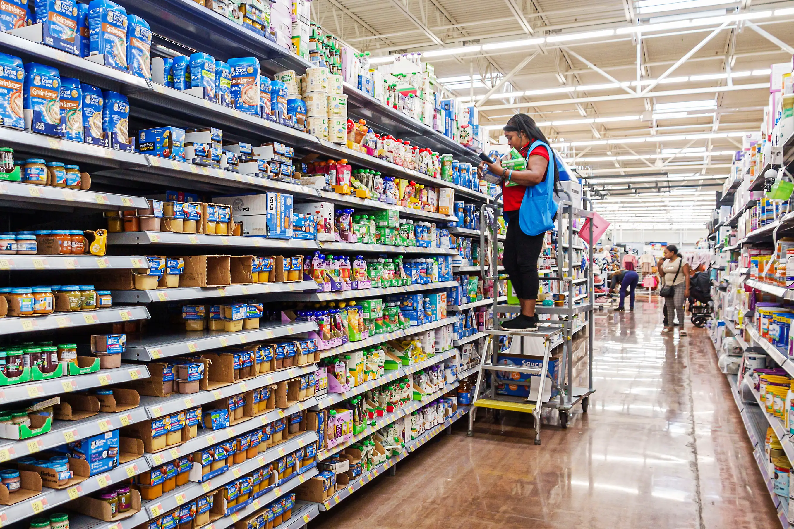 North Miami Beach, Florida, Wal-Mart department store and a stocking clerk using a stepladder.