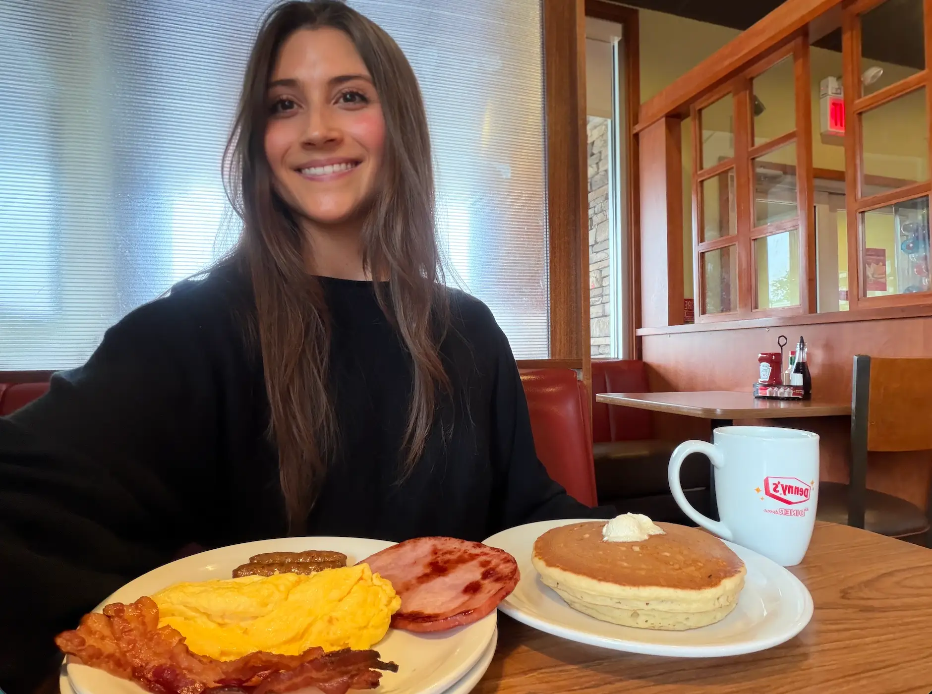 Woman smiling with a breakfast at Denny's