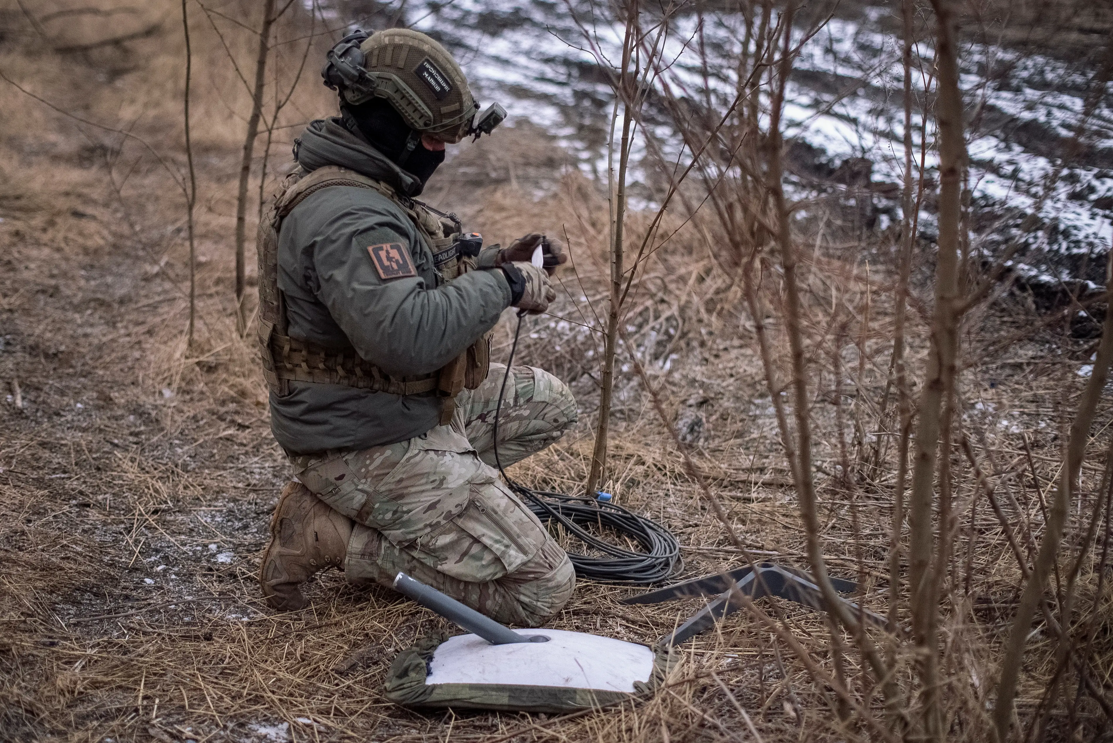 A Ukrainian serviceman of 47th brigade prepares a Starlink satellite internet system.
