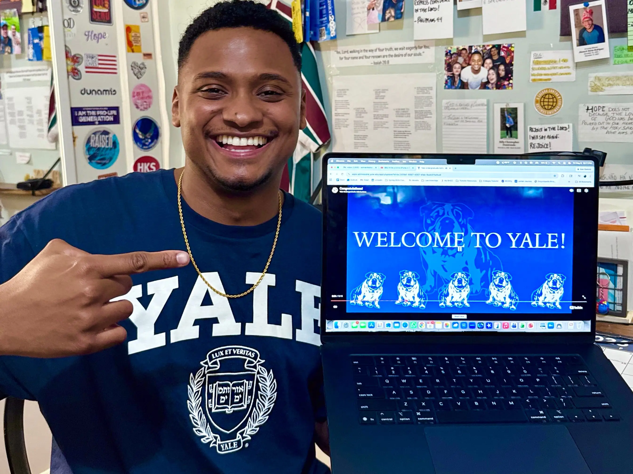 Young man holding acceptance to Yale