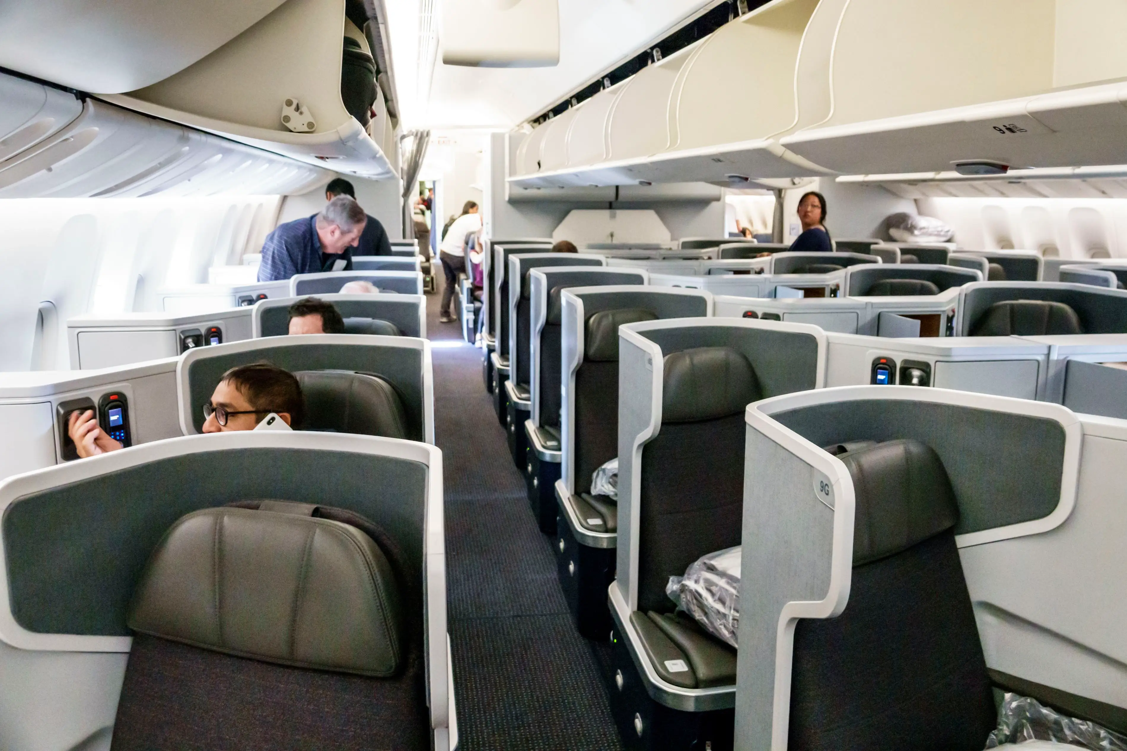 Passengers are in the premium cabin inside an American Airlines flight