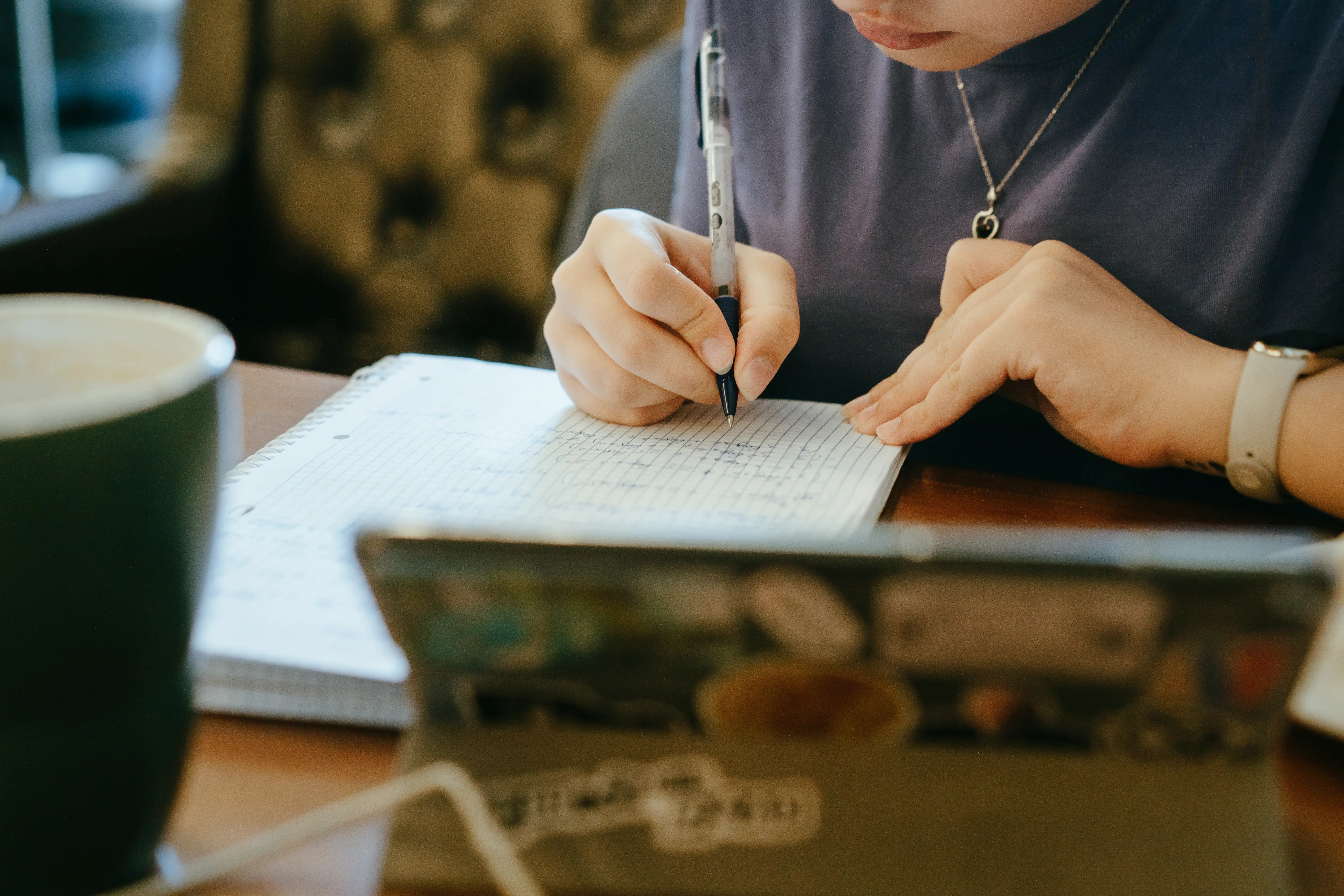 A teenage girl engaging in focused study at a desk,.