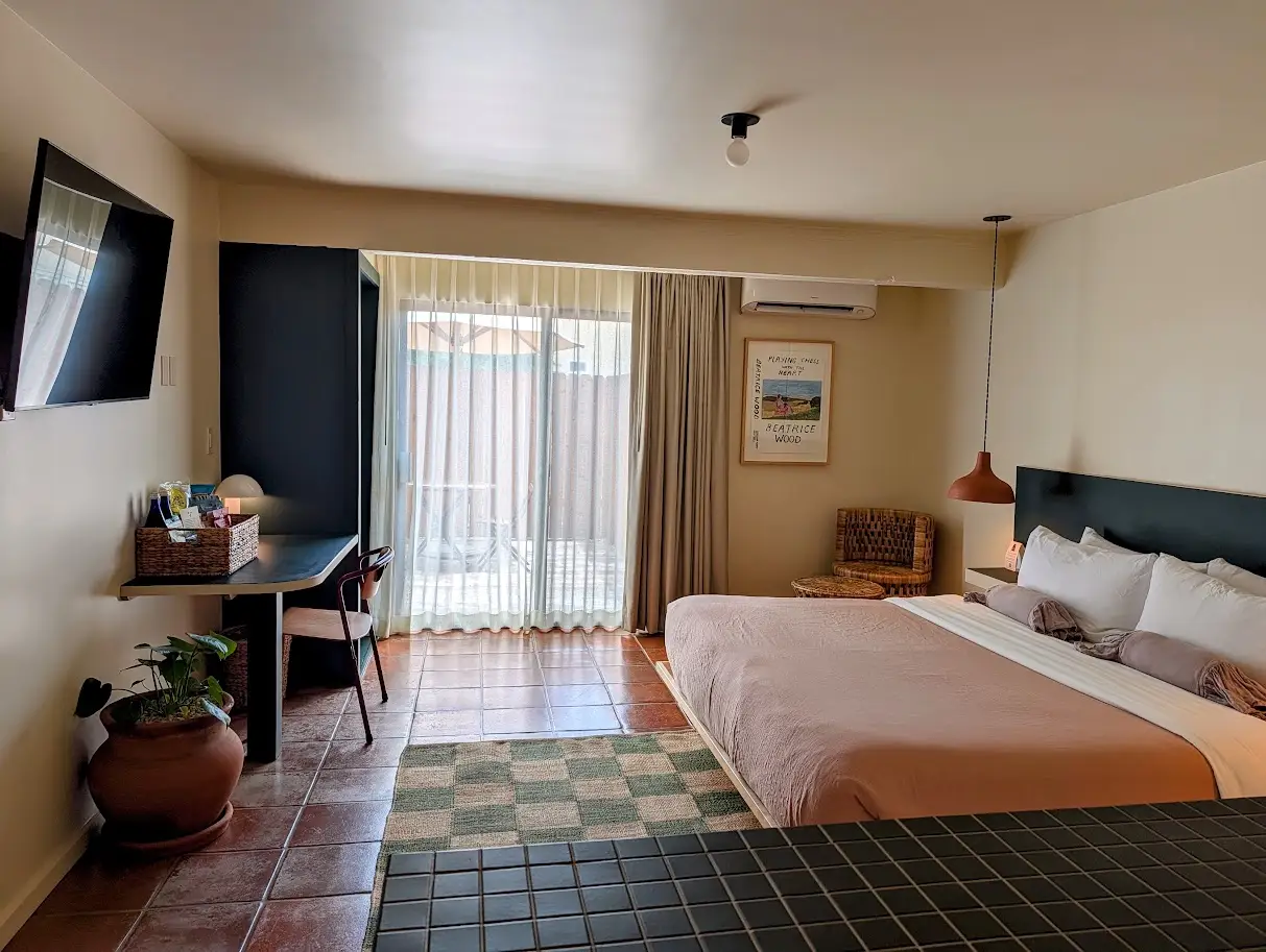 Room with sliding door, tile floor in Hummingbird Inn