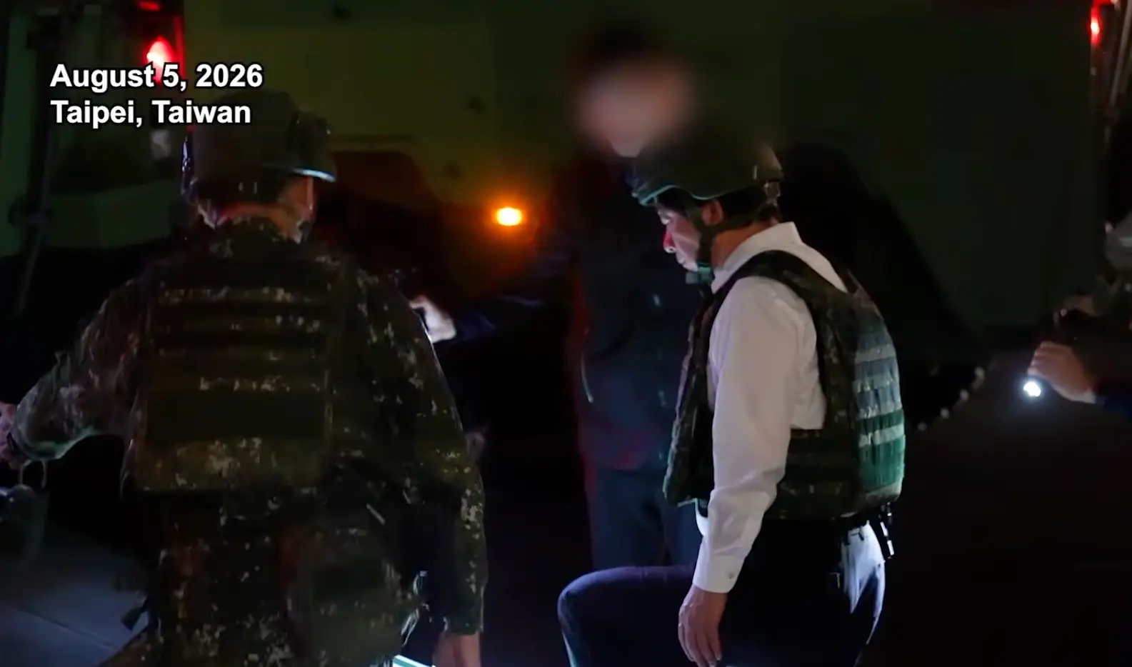 Lai Ching-te wears body armor and a helmet as he boards the ramp to an armored vehicle.