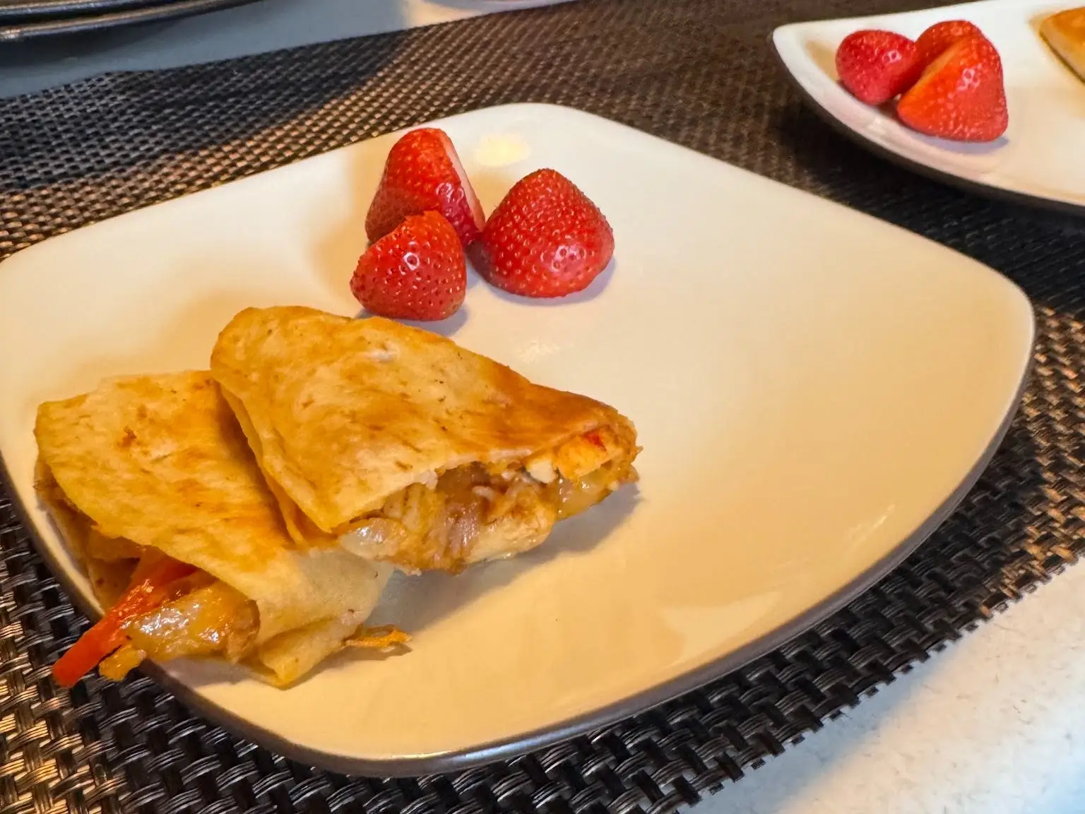 Quesadillas and fruit on pla