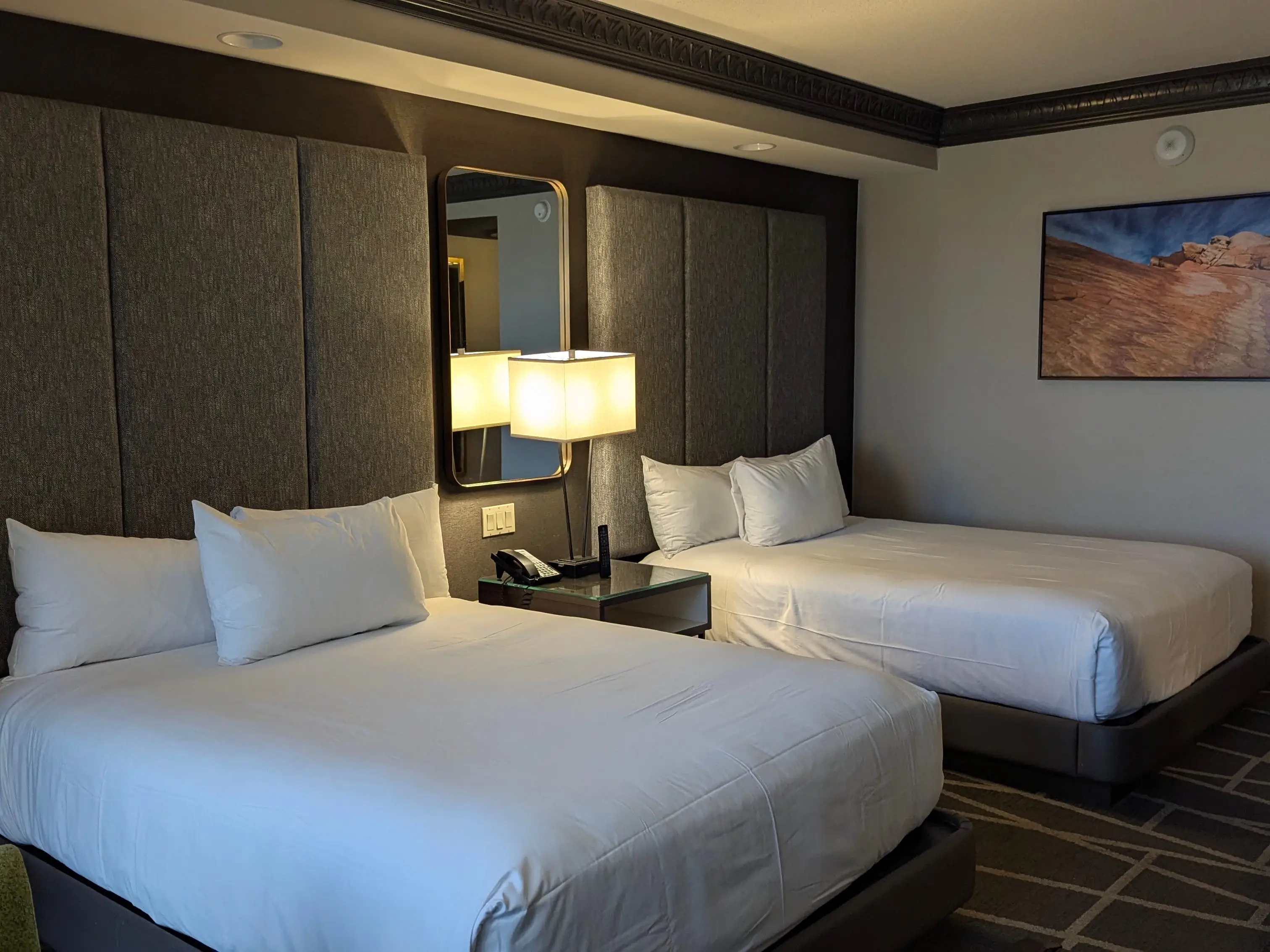 A hotel room with two queen-size beds.