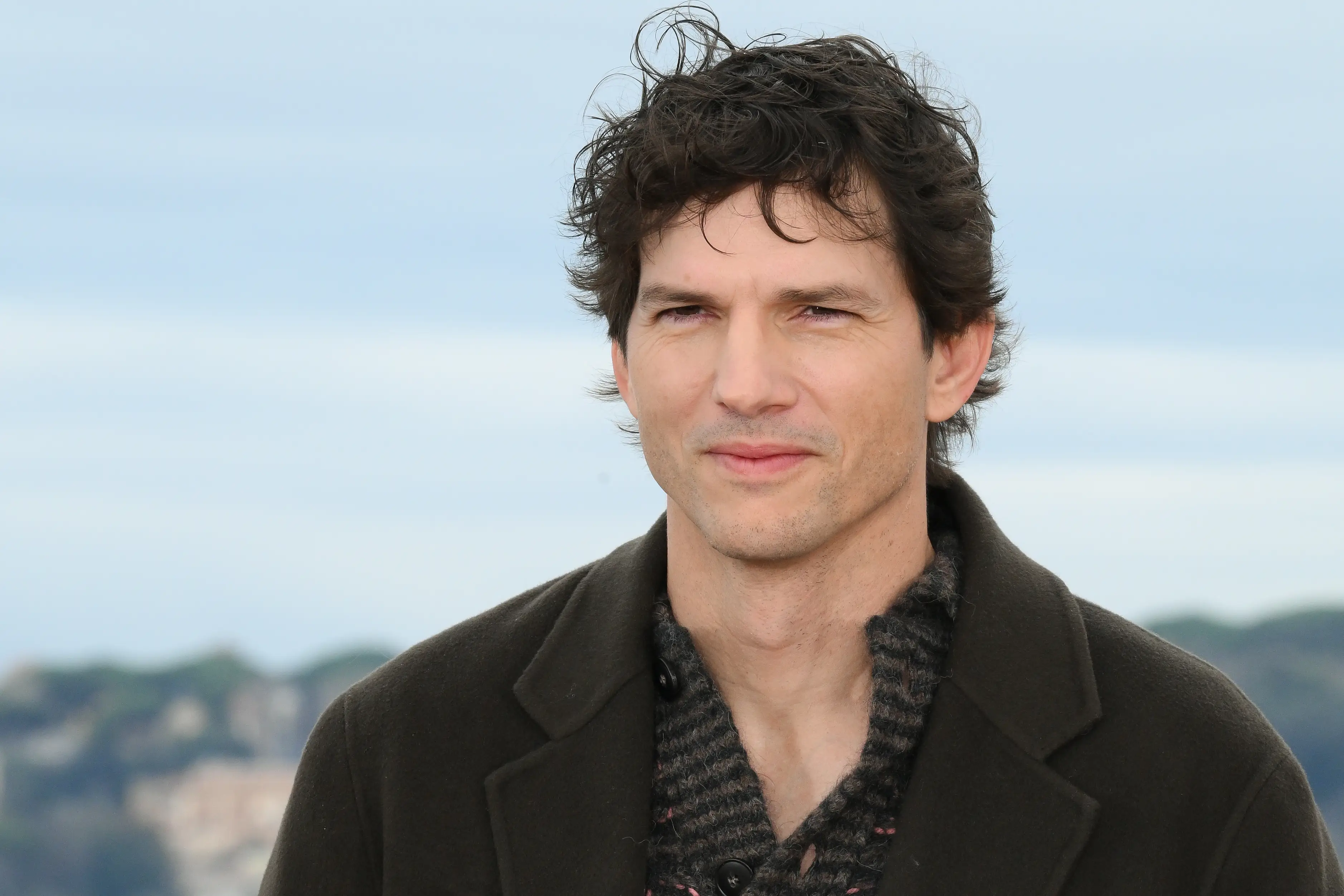 Ashton Kutcher in a dark jacket