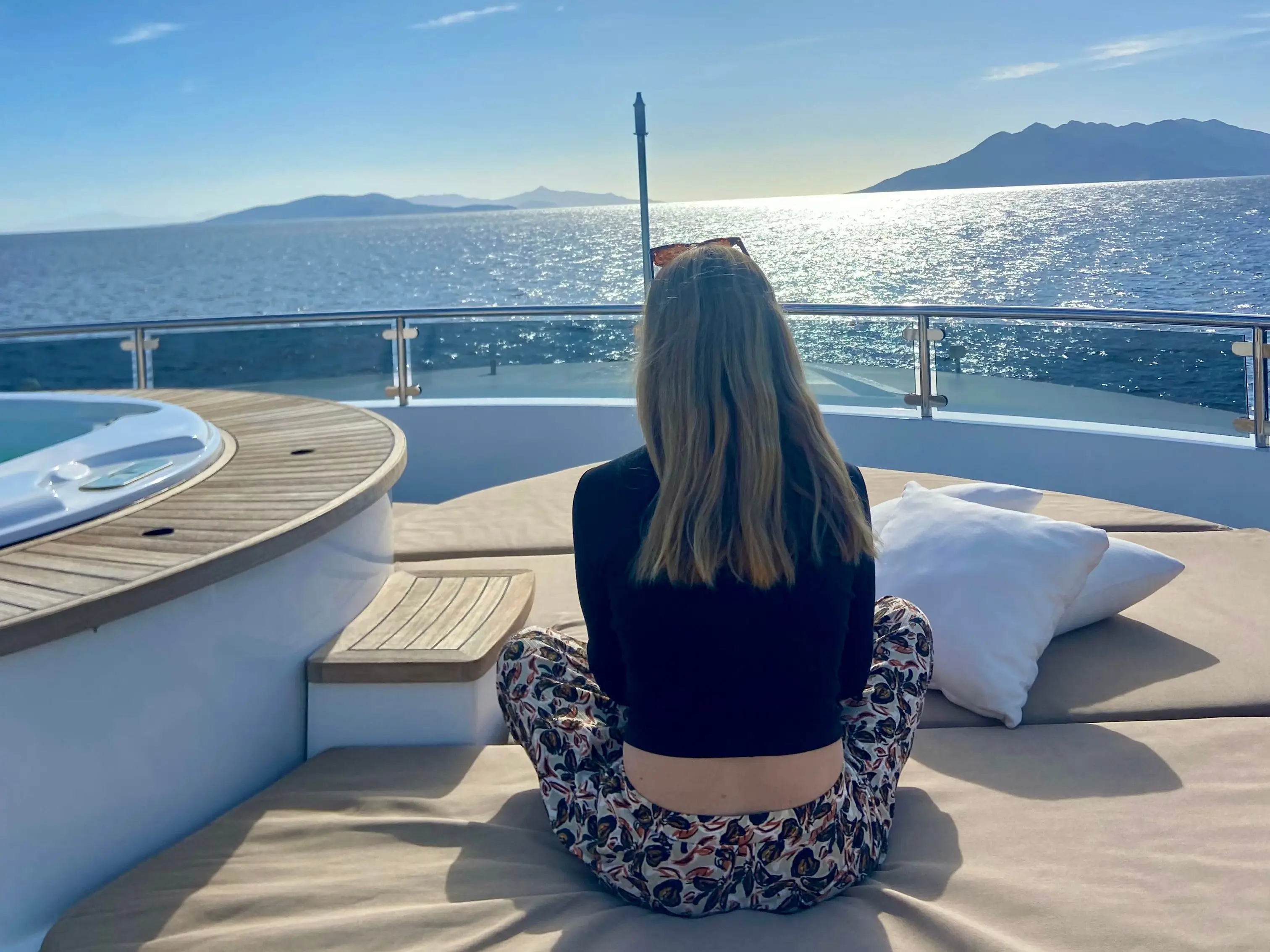 woman sitting on yacht looking at w