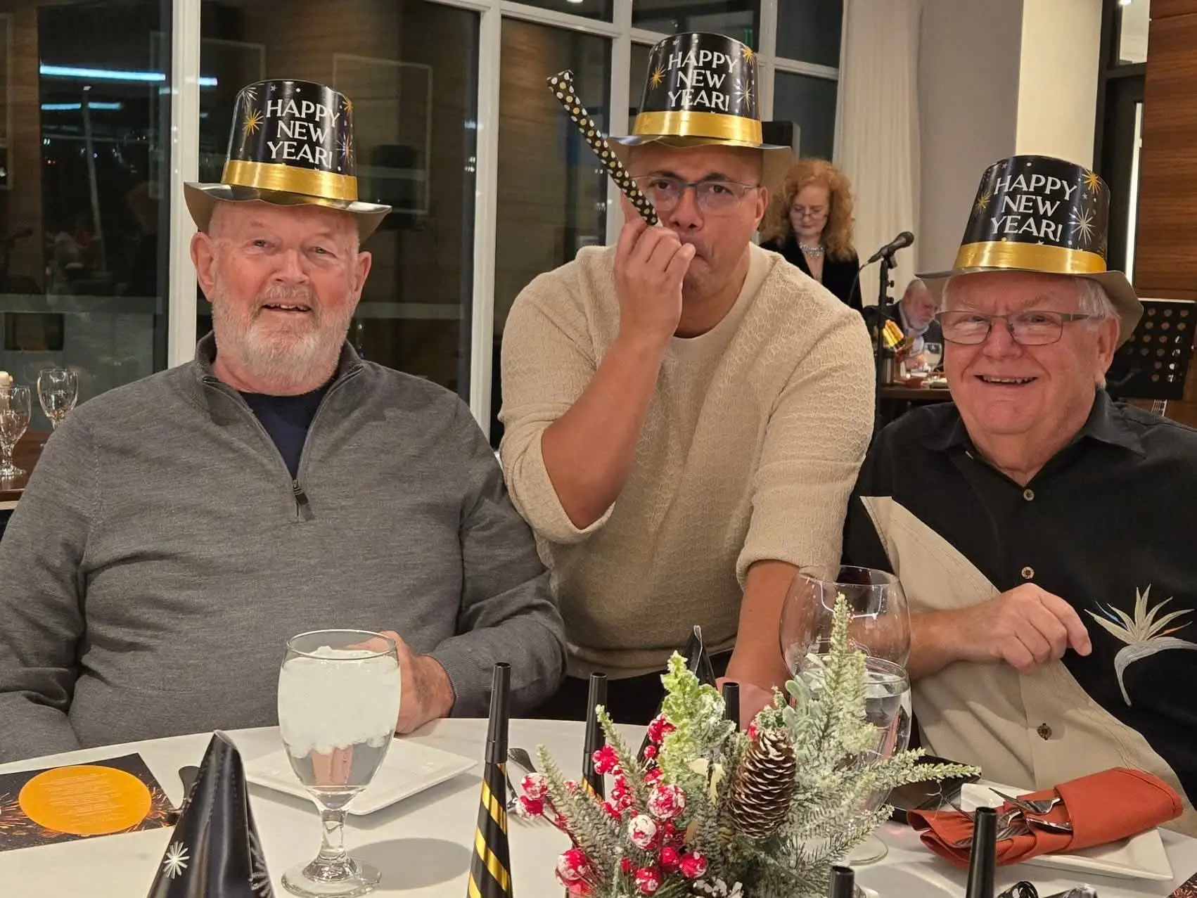 Three middle-aged men at a New Year's Eve party.