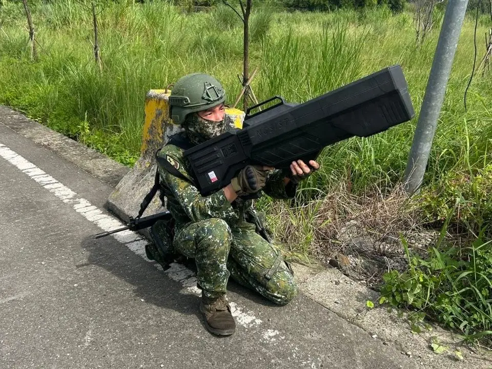 A Taiwanese soldier holds a bulky anti-drone gun.